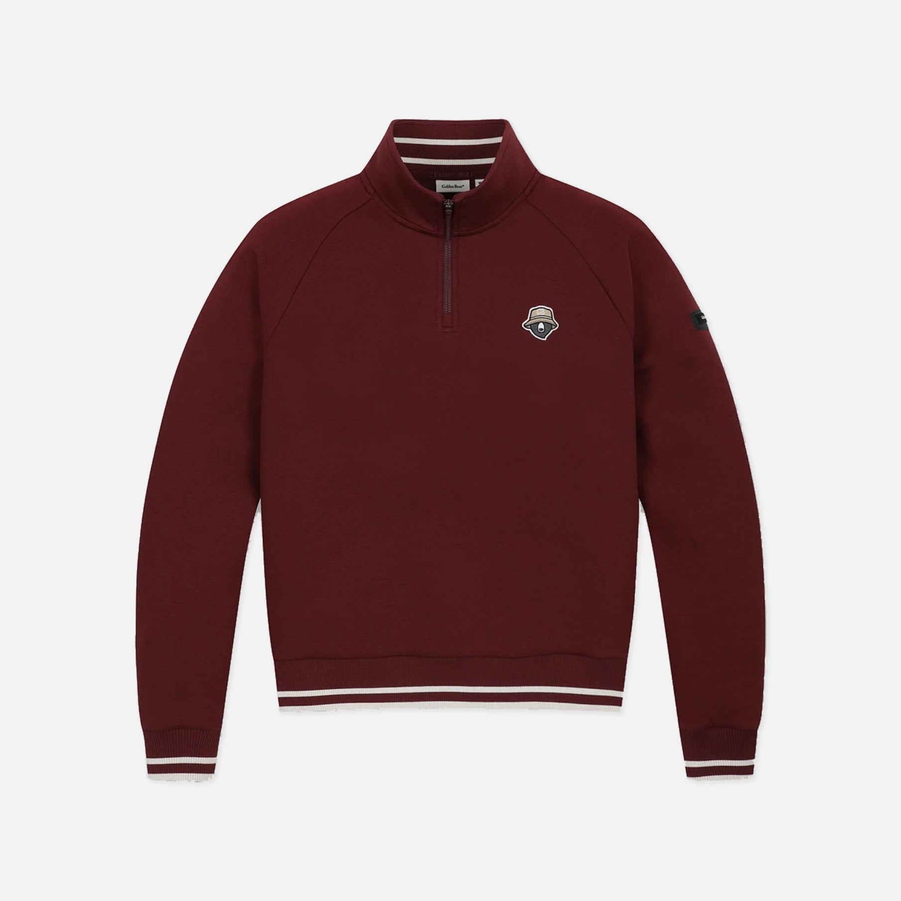 A maroon long-sleeve quarter-zip pullover sweatshirt with white striped ribbing on the collar, cuffs, and hem, featuring a small embroidered shield logo on the left chest.