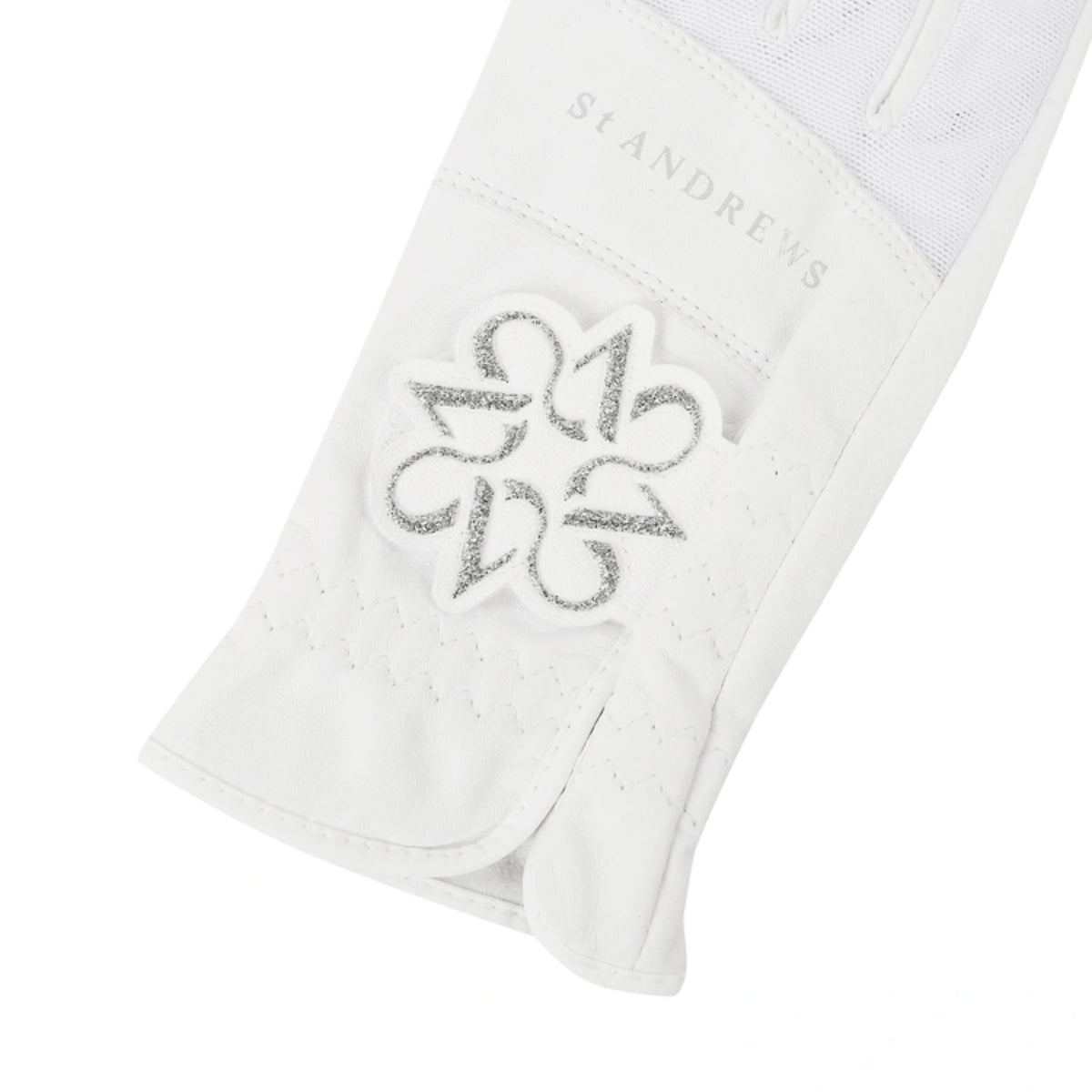 A close-up of a white St Andrews equestrian protective boot or leg guard, showing the brand name 'ST ANDREWS' and a silver embroidered logo patch on a white background.