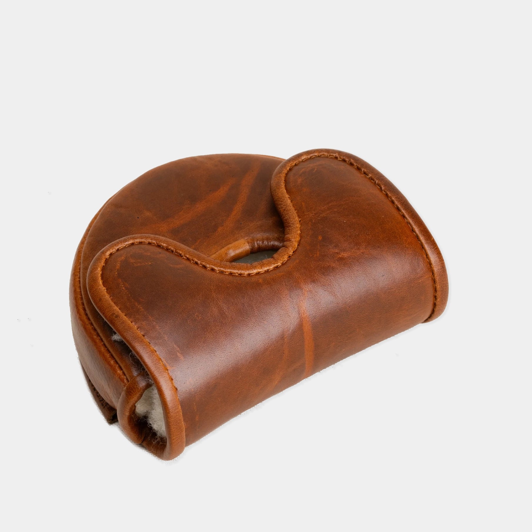 A brown leather OZ1 Putter Cover with a curved, ergonomic shape and a stitched strap closure, shown on a light gray background.