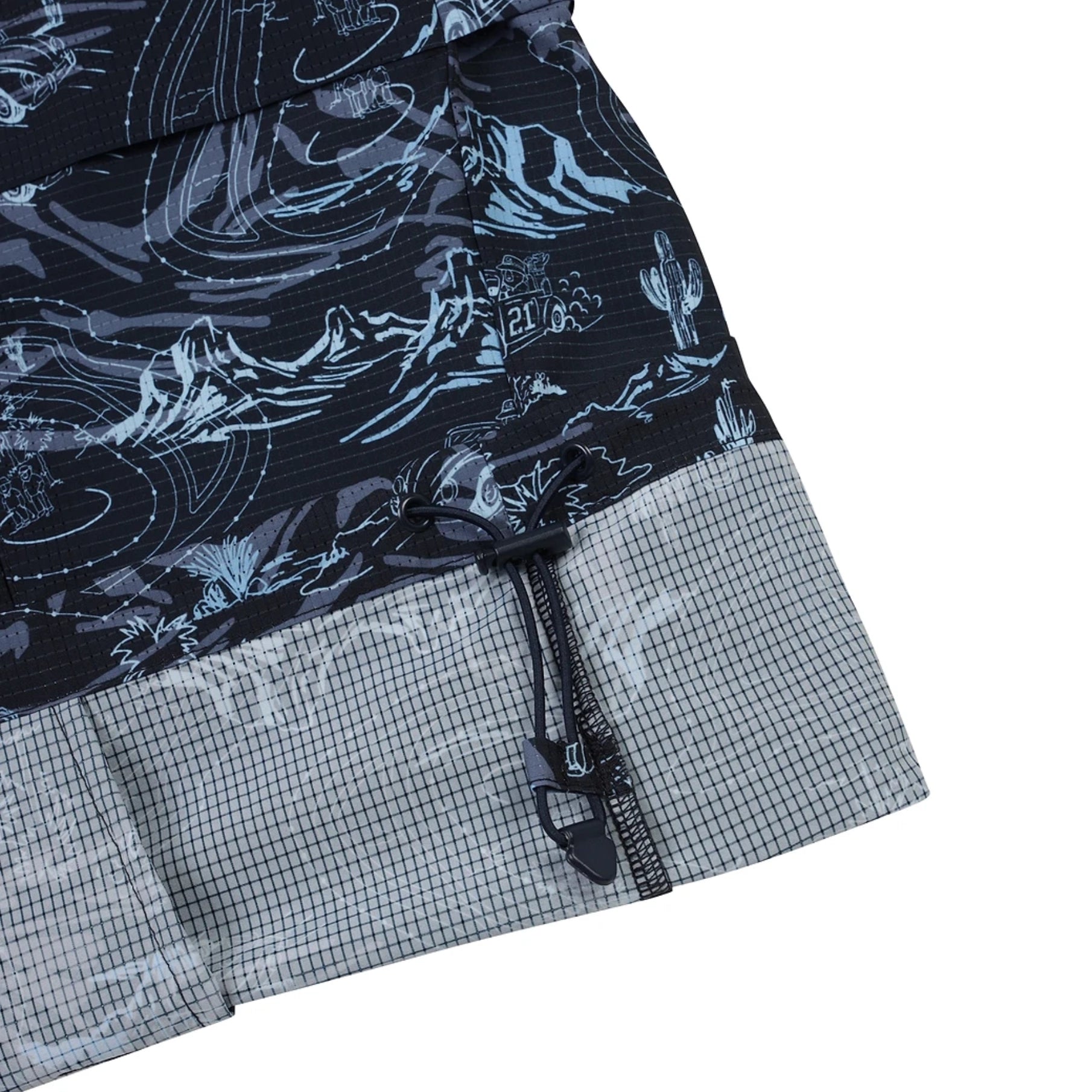 Close-up of a pair of shorts showing a dark navy and light blue abstract wave pattern on the upper portion and a gray grid-textured lower hem, with a black drawstring closure.