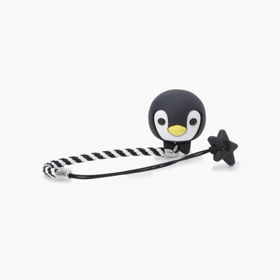 A black and white striped elastic hair tie featuring a cute 3D penguin character holding a small black star, set against a plain light gray background.