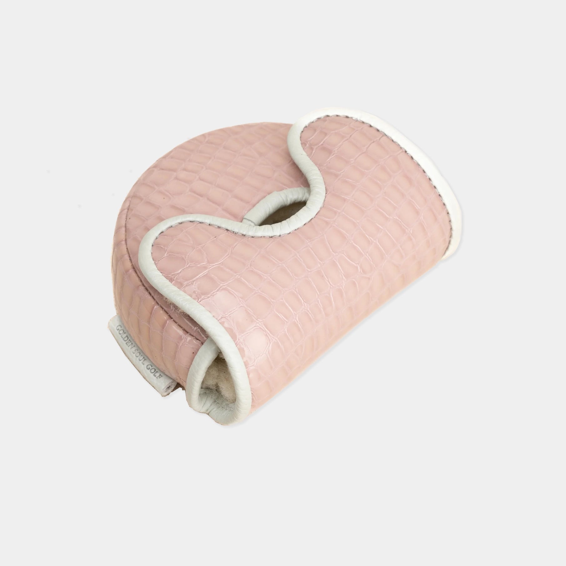 A light pink crocodile-embossed leather golf club headcover with white trim, shown on a light gray background.