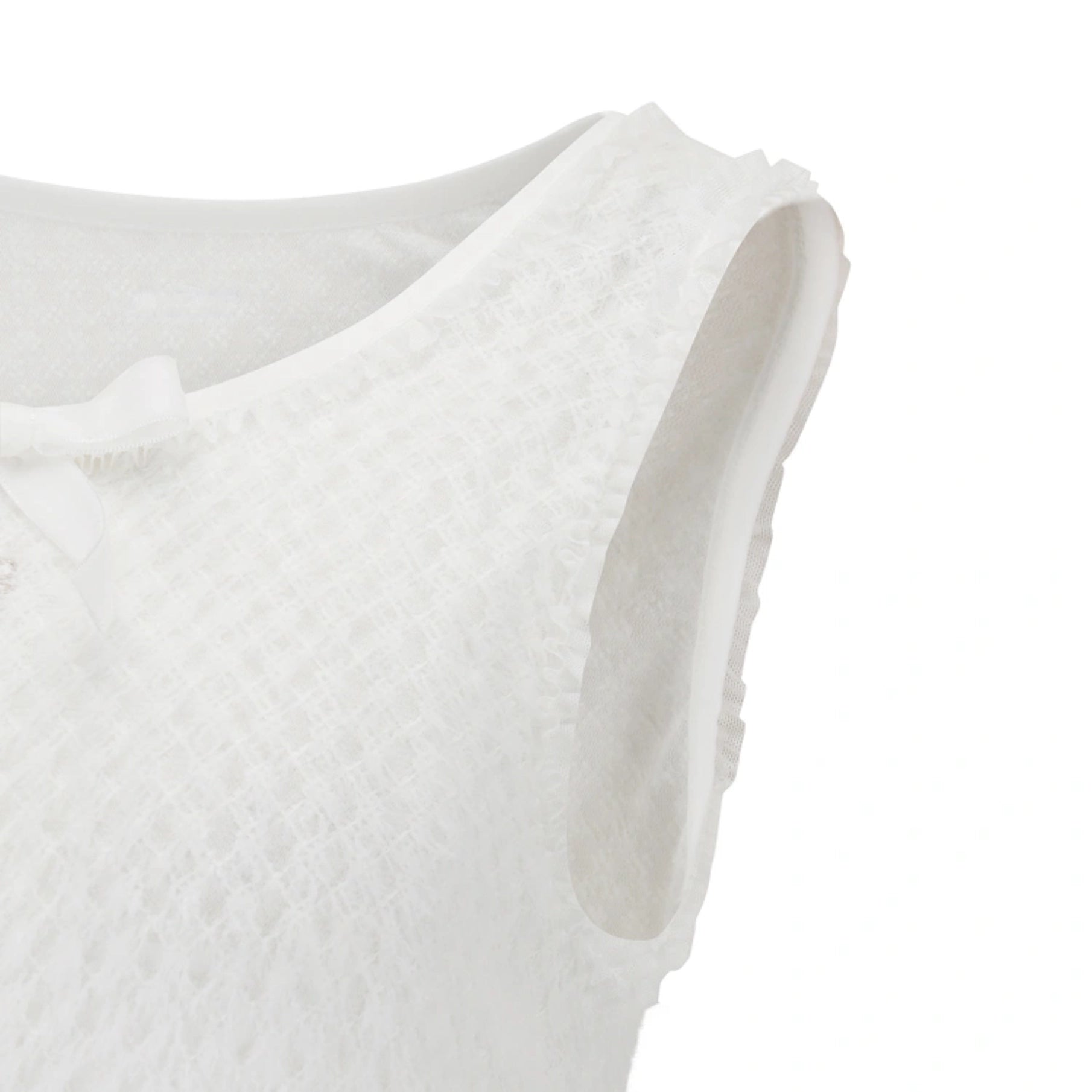 Close-up of a white sleeveless textured top with a ruffled neckline and a small bow detail on the left side, shown against a plain white background.