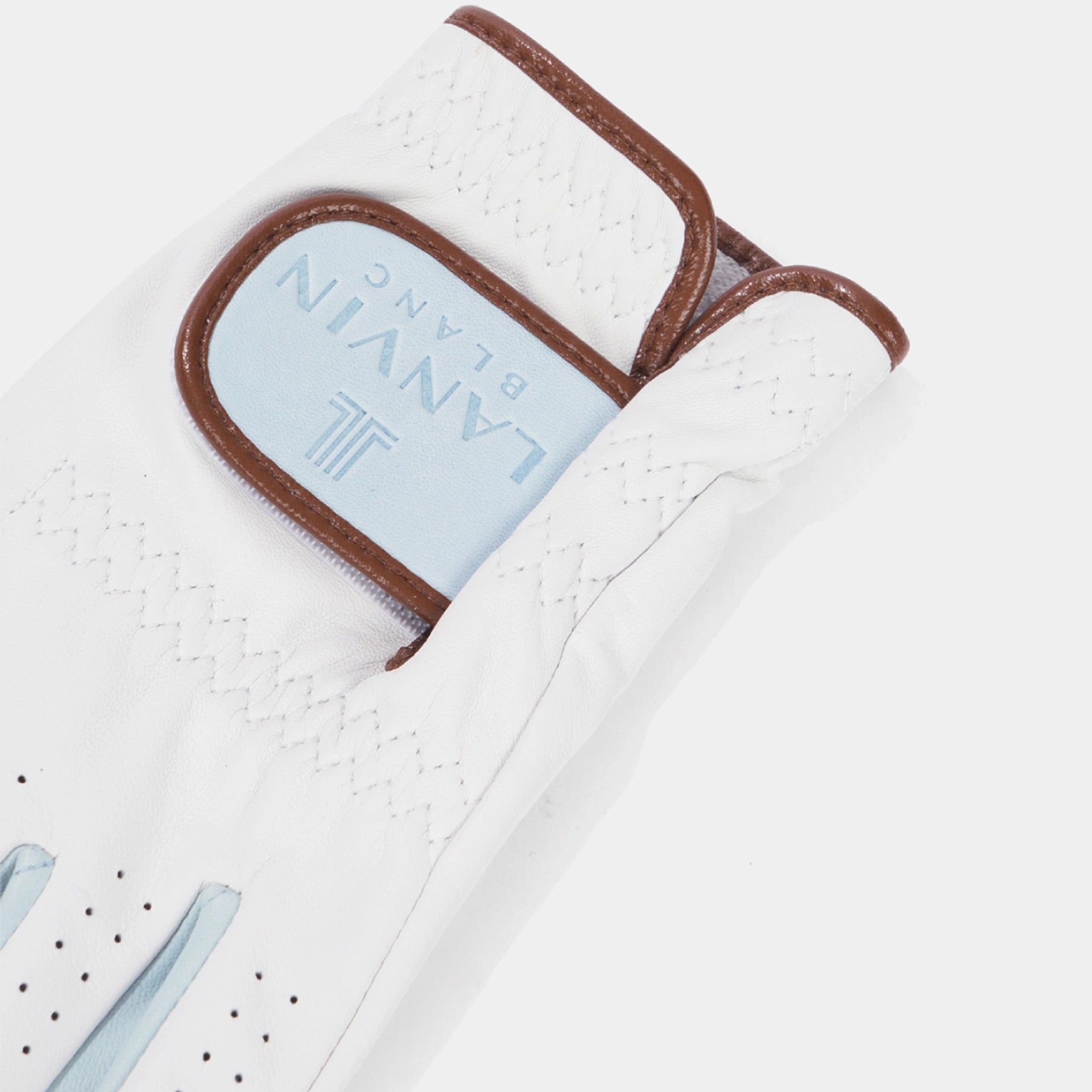 A close-up of a white golf glove with brown trim and a light blue brand patch reading LANYN BLANC, shown on a clean white background.