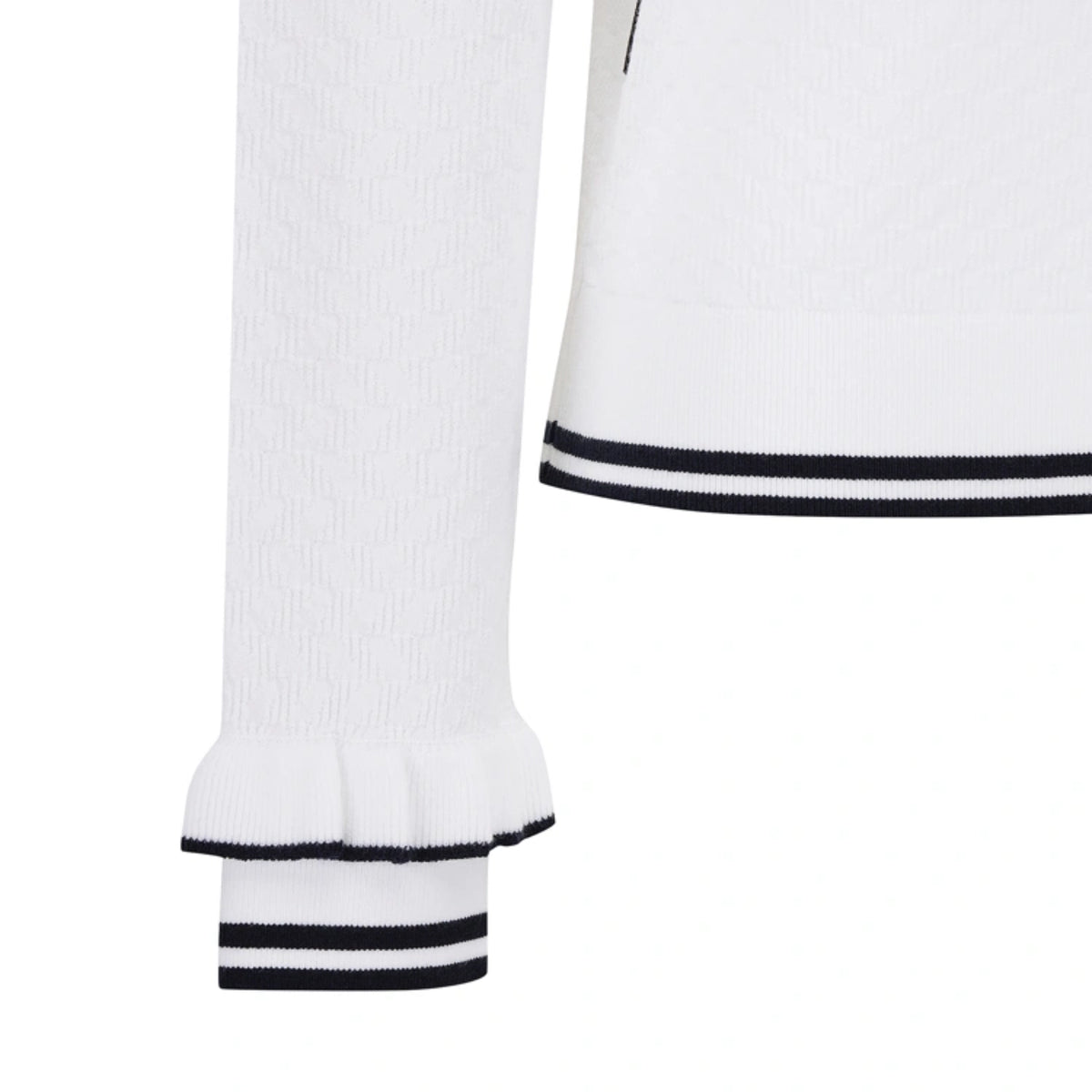 Close-up of a white ribbed knit top with black and white striped trim at the hem and sleeve cuff, shown on a plain white background.