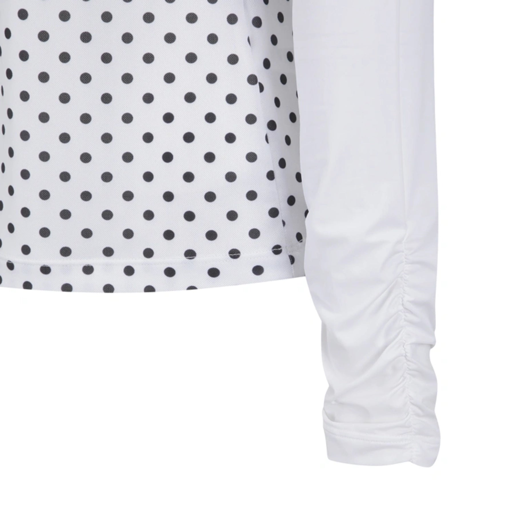 Close-up of a white long-sleeve top with black polka dots on the chest and a ruched sleeve, shown against a plain white background.