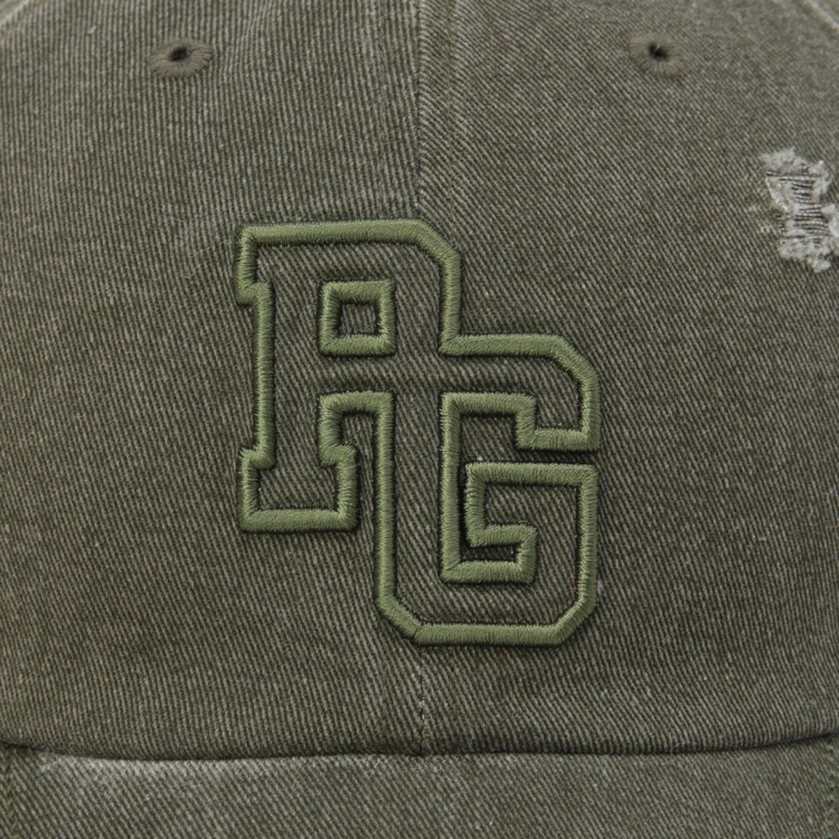 Close-up of an olive green baseball cap featuring a large embroidered 'RG' monogram logo on the front panel.