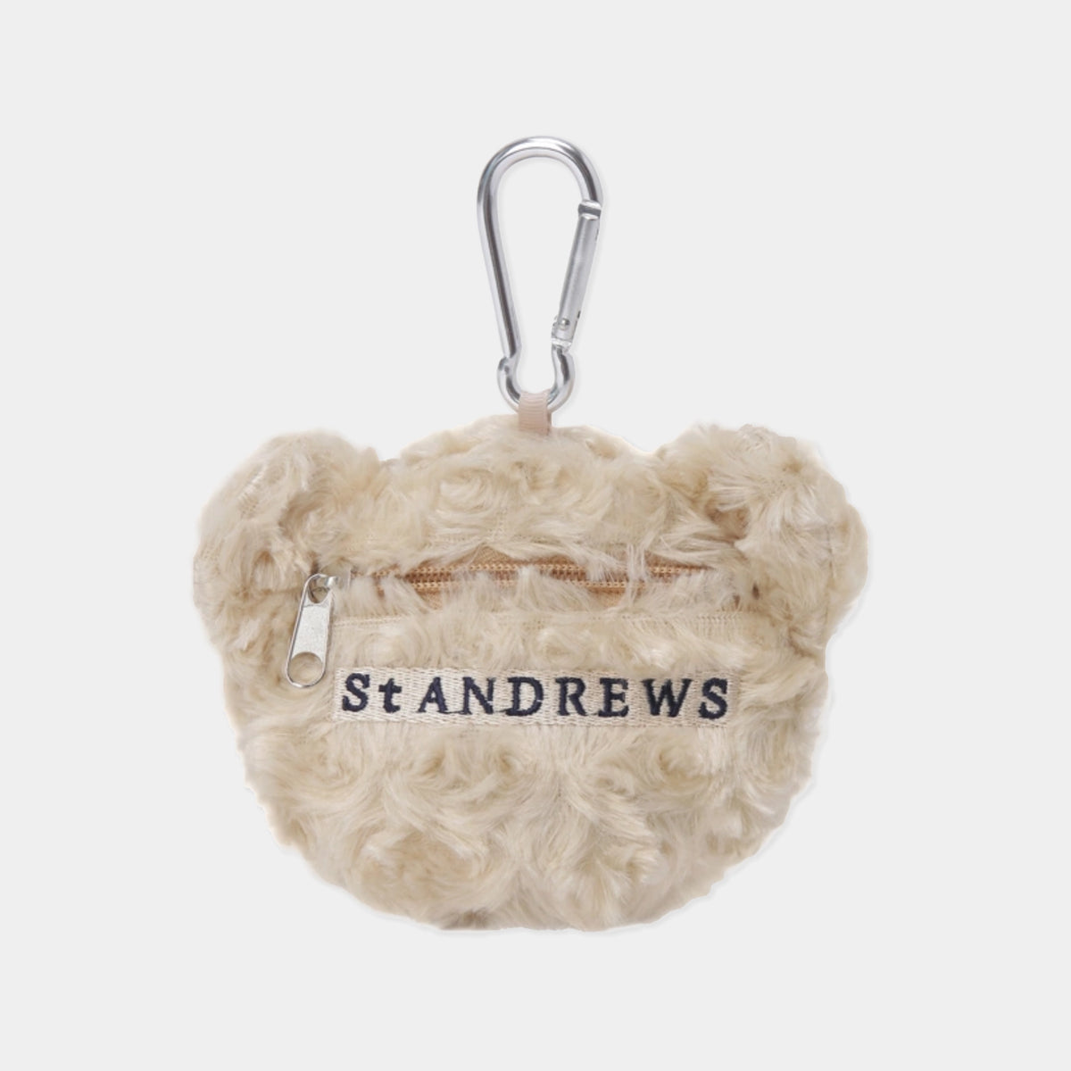 A beige curly faux-fur mini pouch with bear ears, featuring a silver carabiner clip and the brand name 'St ANDREWS' embroidered in navy on the front, set against a light gray background.