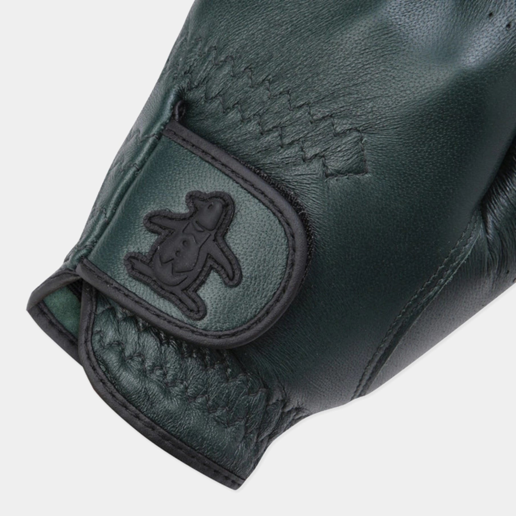 Close-up of a dark green leather glove with a black penguin logo patch on the wrist strap, set against a light gray background.
