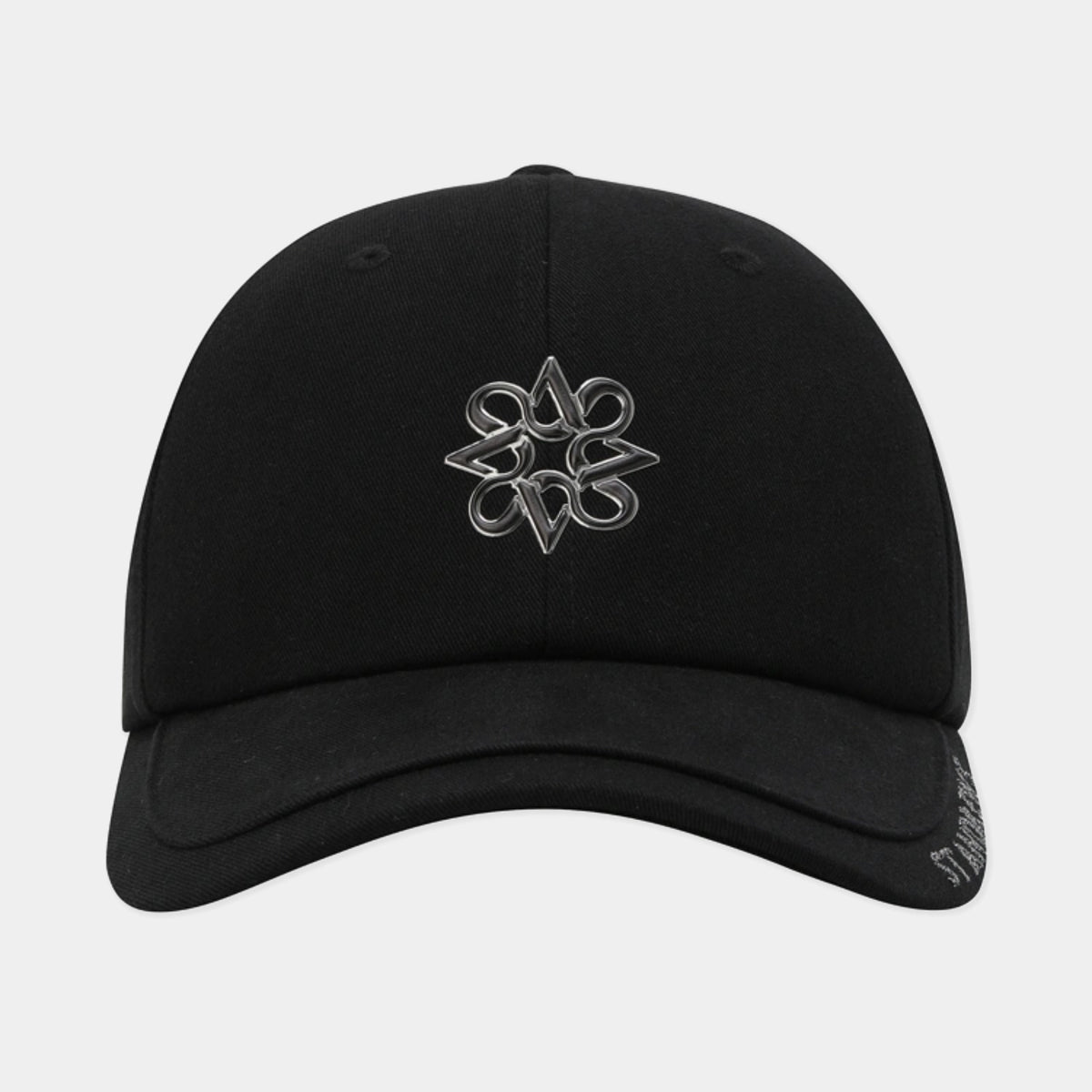 A black baseball cap with a metallic silver embroidered logo on the front, shown against a light gray background.