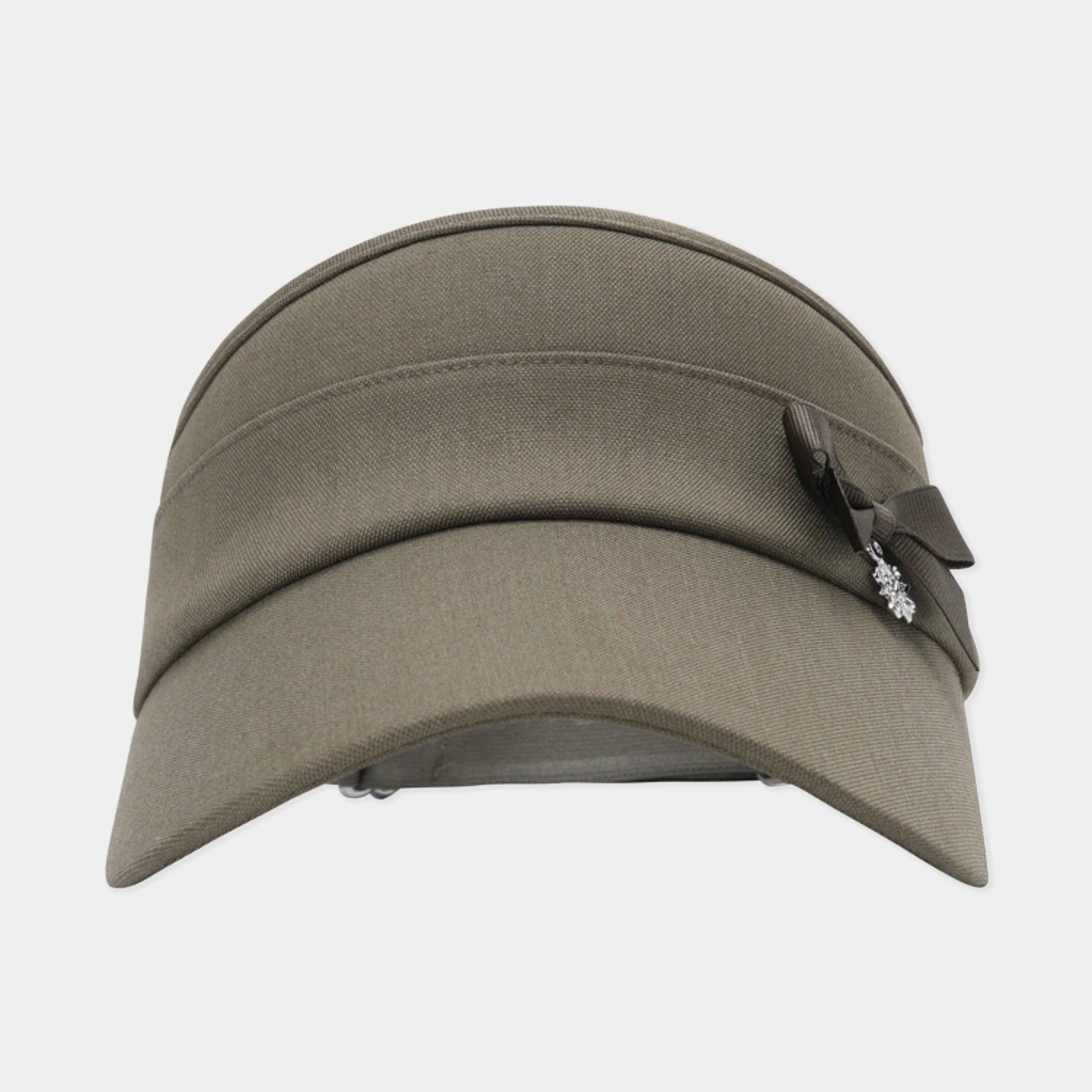 An olive green military-style visor hat with a dark brown ribbon bow and a small silver crystal embellishment on the side, shown against a light gray background.