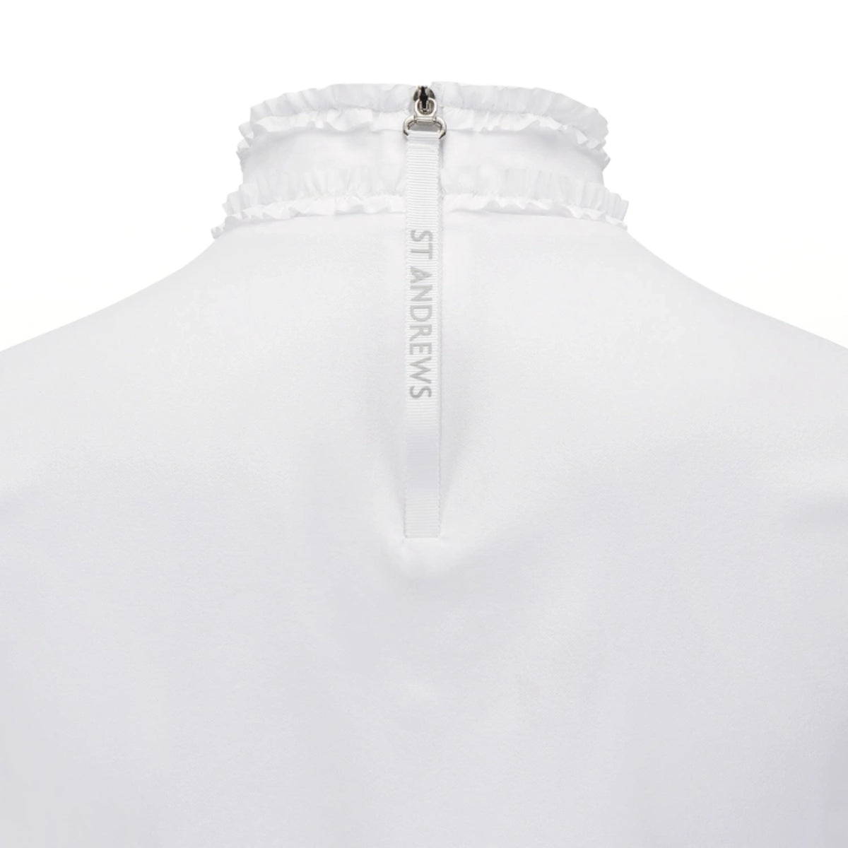 Close-up back view of a white St. Andrews zip-up garment with a gathered ruffled collar and a vertical white zipper pull printed with the brand name.
