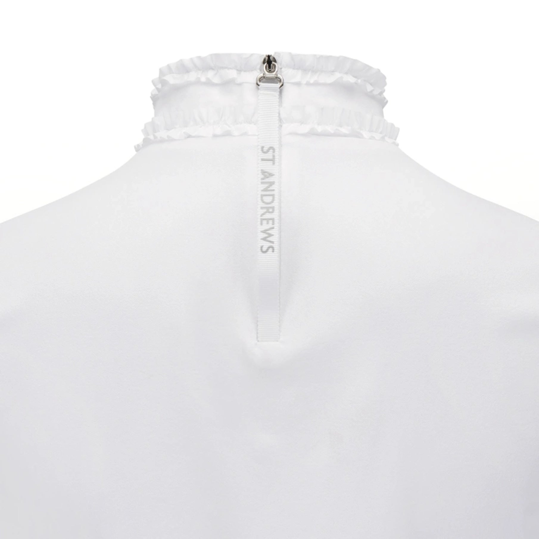 Close-up back view of a white St. Andrews zip-up garment with a gathered ruffled collar and a vertical white zipper pull printed with the brand name.