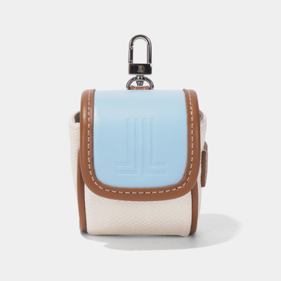 A small camera pouch with a light blue front flap, tan leather trim, and a textured off-white body, featuring a silver metal carabiner clip on top.