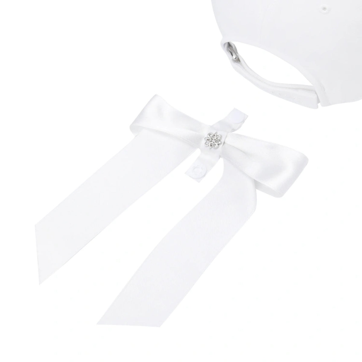 White baby bonnet with a satin ribbon bow and a small rhinestone center accent, shown on a plain white background.