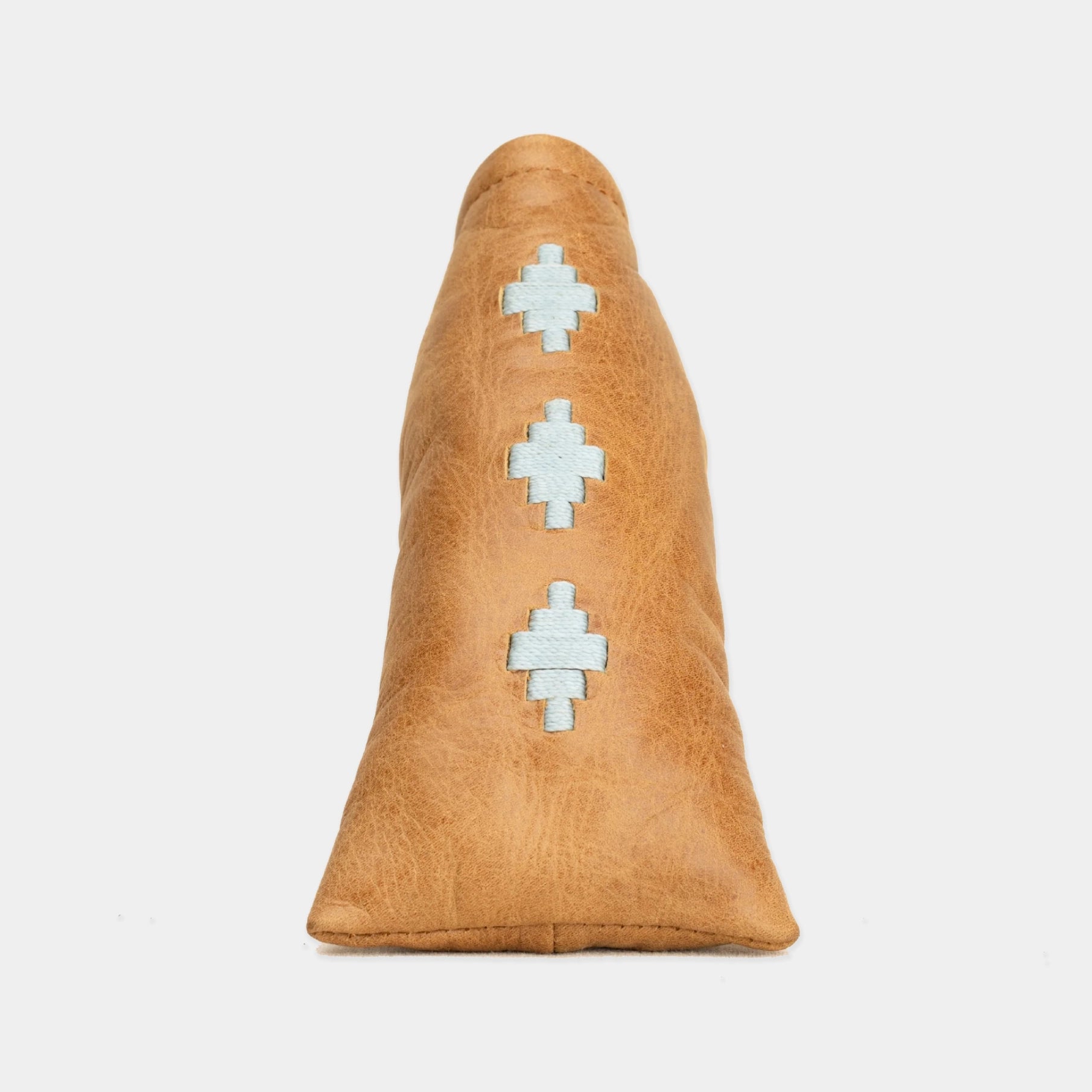 A tan leather blade putter cover with three light blue geometric patterns stitched vertically down the center, shown against a plain light gray background.