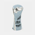 A light blue denim golf club headcover featuring a white distressed flag graphic with a skull and crossbones, a black feather illustration, and the text &