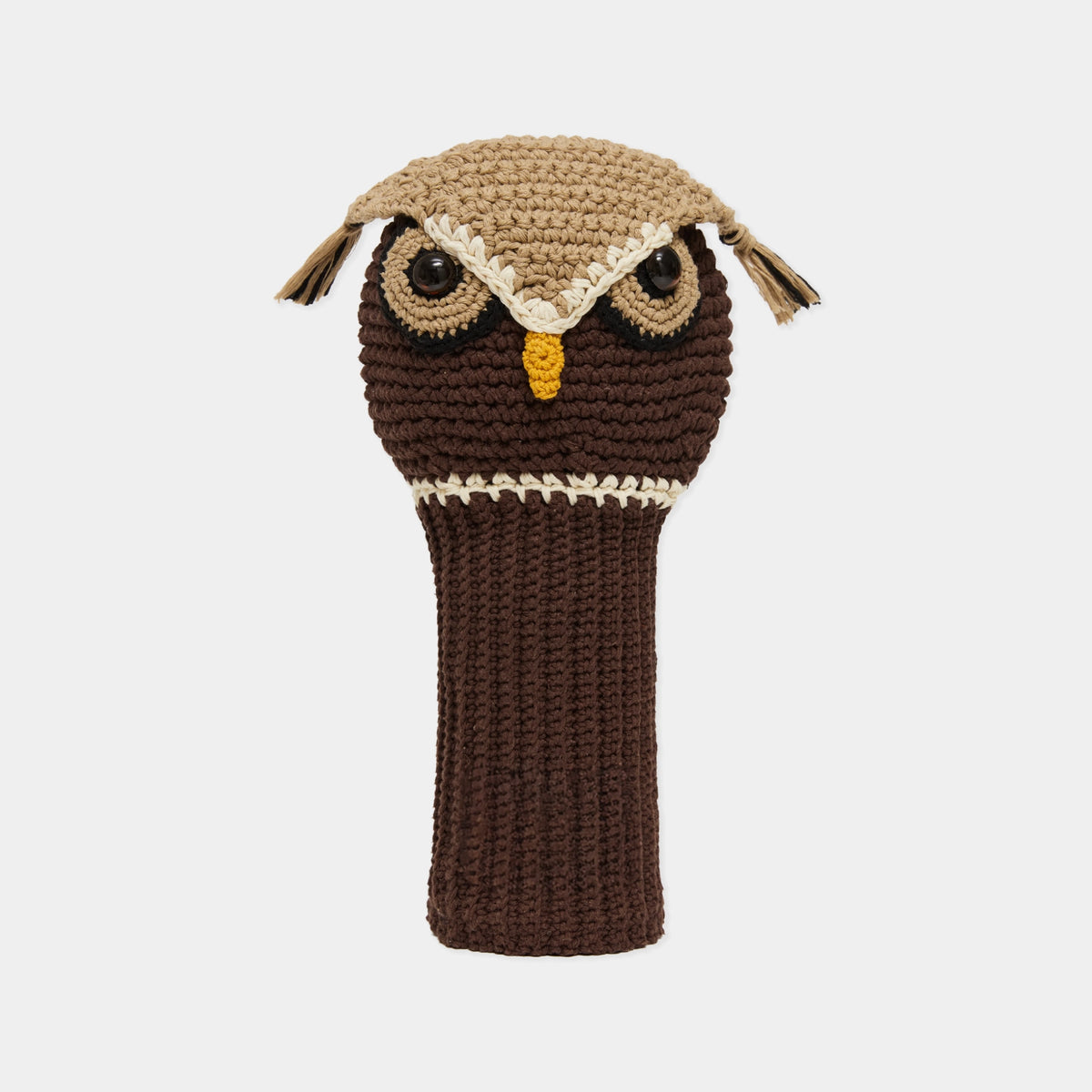 A crocheted owl-shaped golf club headcover in dark brown and tan, featuring embroidered eyes, a yellow beak, and ear tufts, shown against a light gray background.