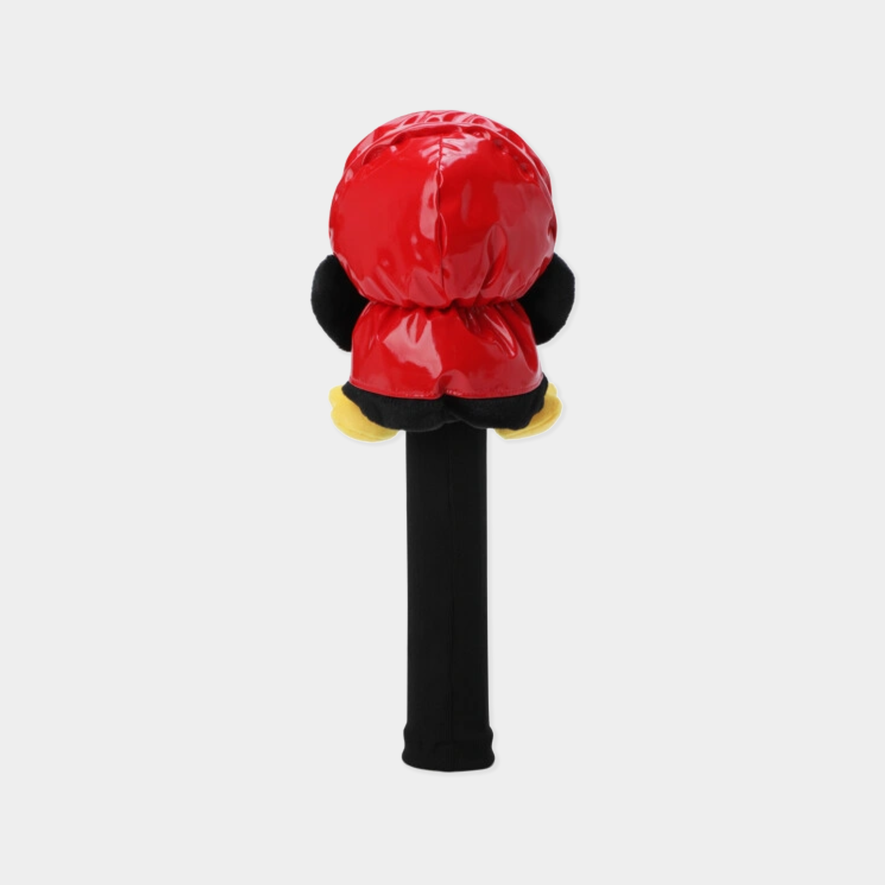 A penguin-themed golf club cover on a light gray background. The cover features a glossy red head with black ears and yellow shoes, mounted on a black shaft.