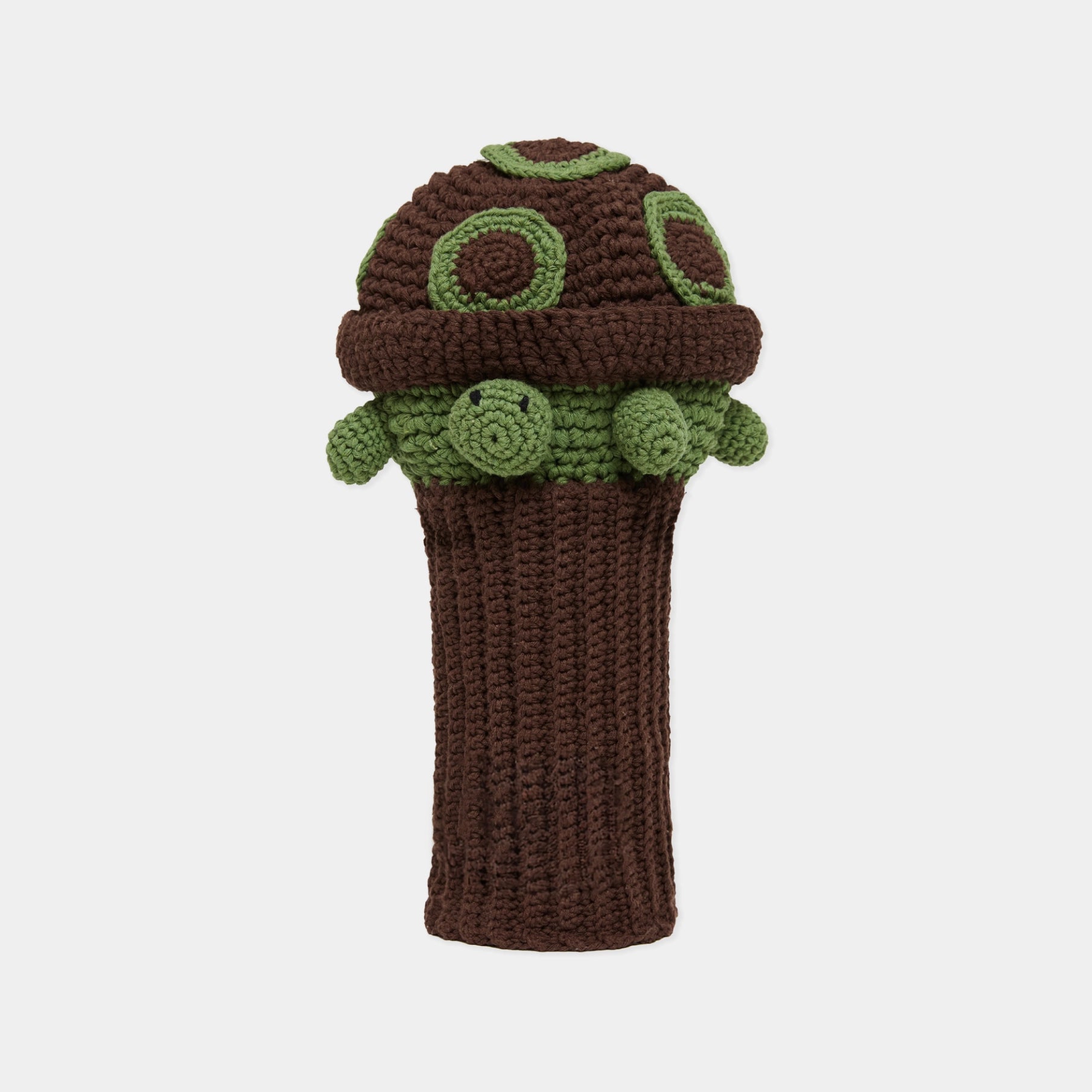 A crocheted golf club headcover shaped like a turtle, featuring a dark brown body and cap with olive green accents and a small embroidered face on the side, shown against a light gray background.