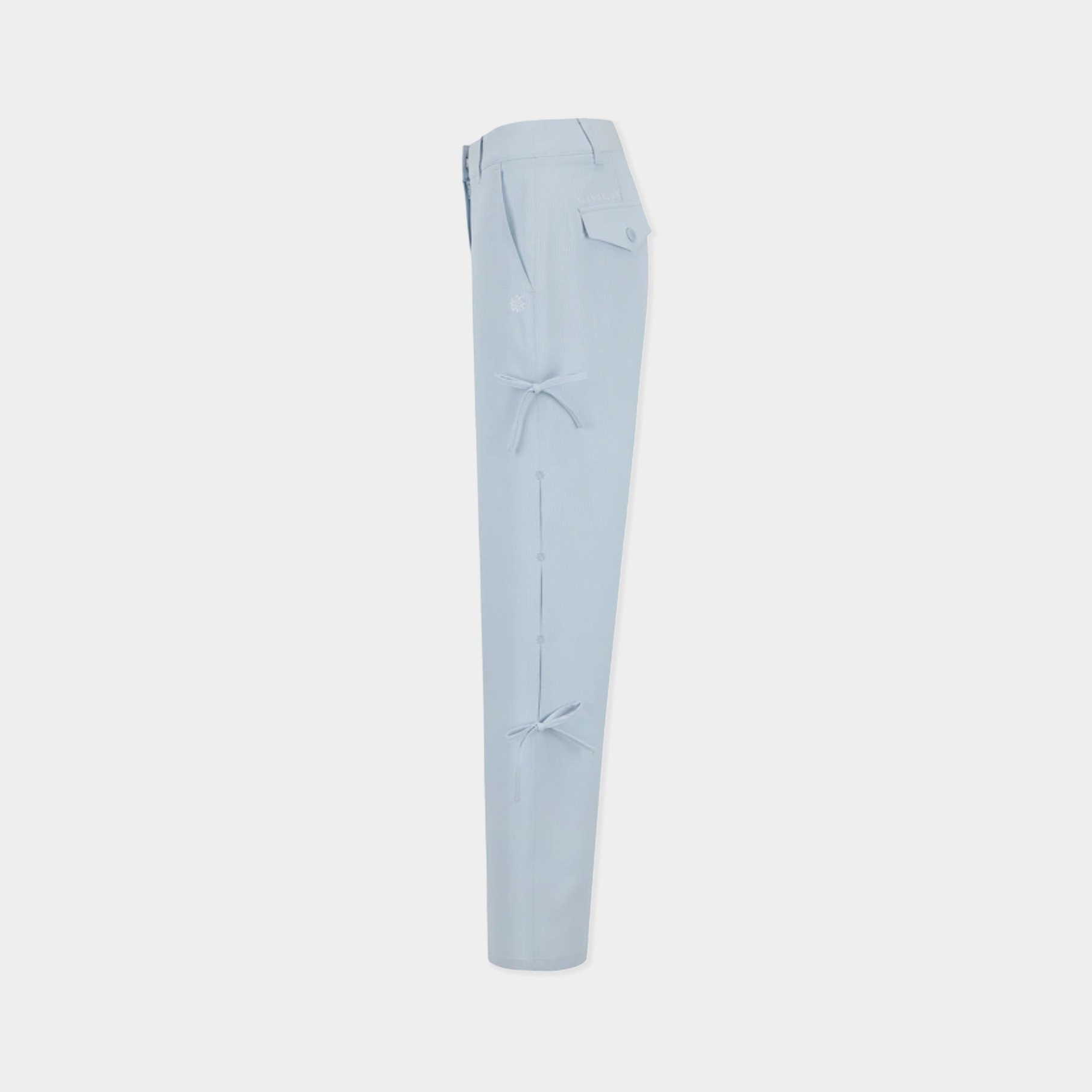 Light blue slim-fit trousers shown from the side against a light gray background.