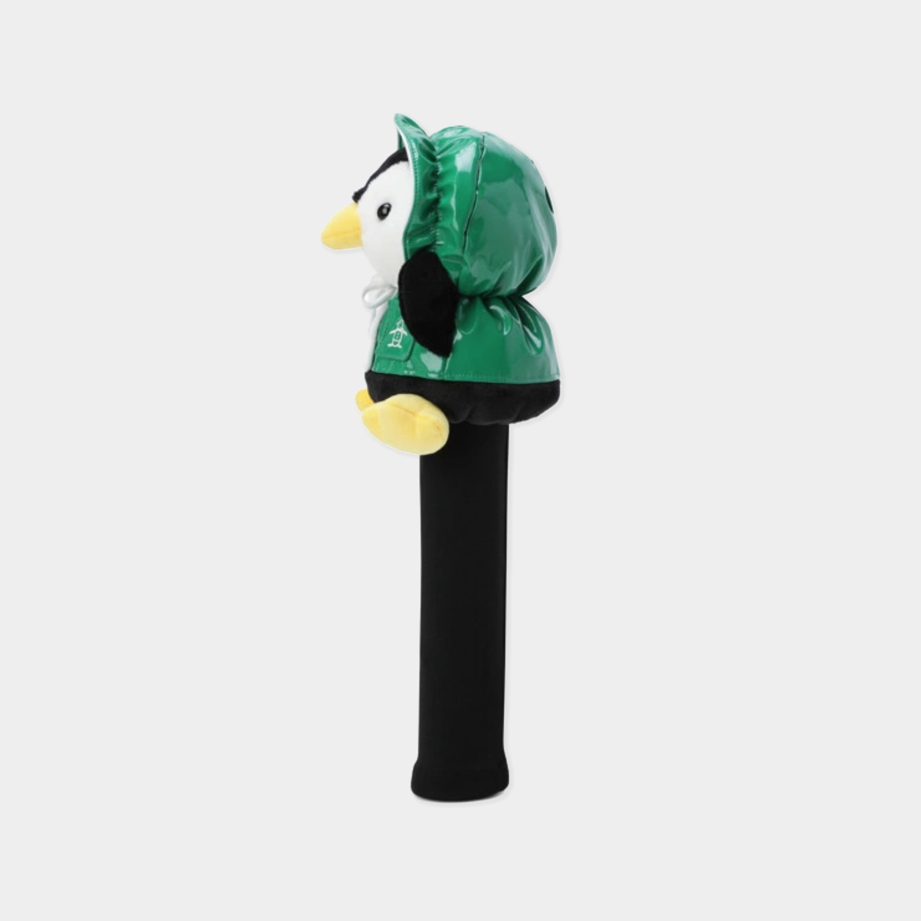 A golf club headcover featuring a plush penguin wearing a shiny green hooded jacket, mounted on a black sleeve, shown against a light gray background.