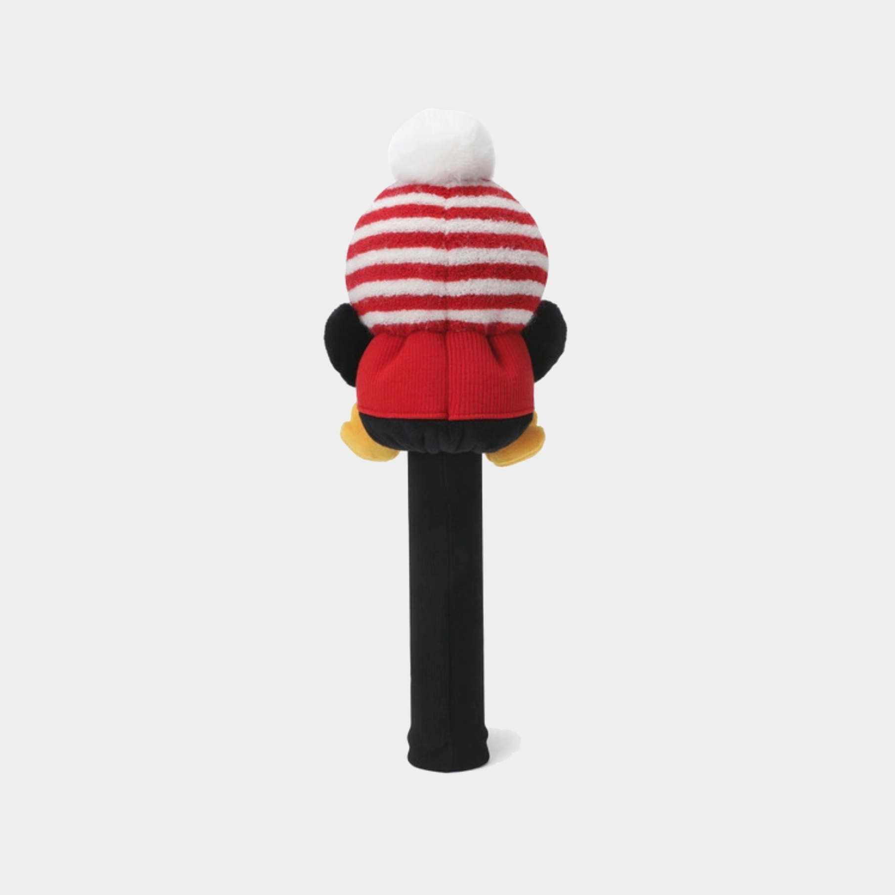 A plush character head on a black stick, featuring a red and white striped knit hat with a white pom-pom, a red knit outfit, black arms, and yellow feet, shown against a light gray background.