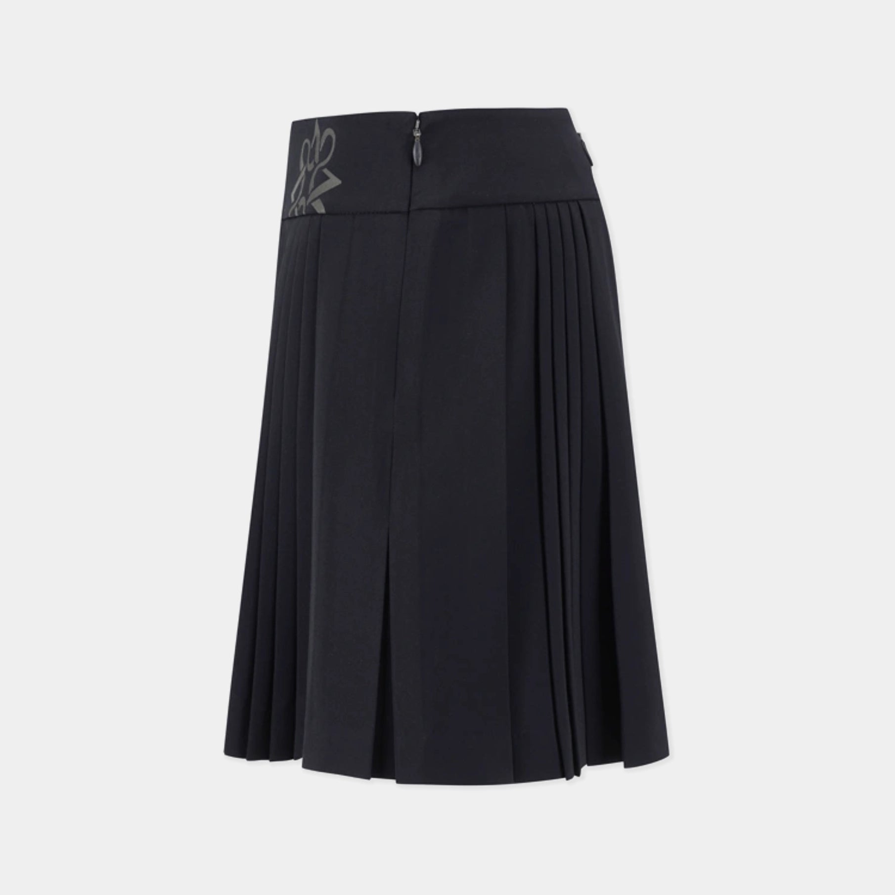 A black pleated A-line skirt with a high waistband, featuring a small gray embroidered monogram logo on the left side of the waistband, shown against a light gray background.