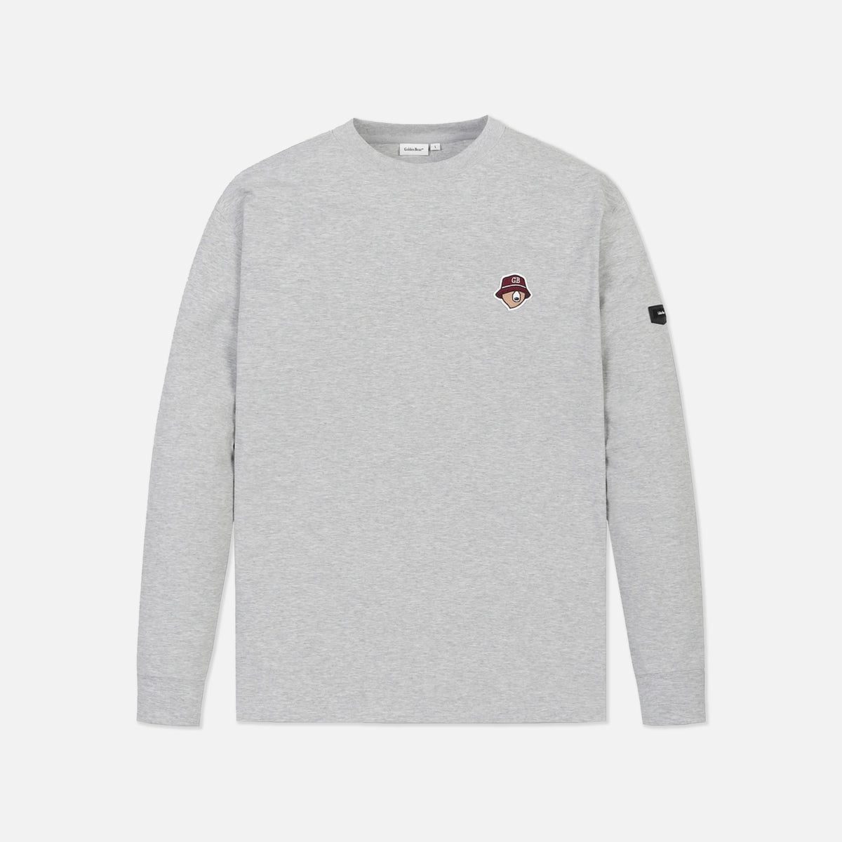 A light gray heather crewneck sweatshirt with a small embroidered patch on the left chest and a black sleeve tag, shown against a light gray background.