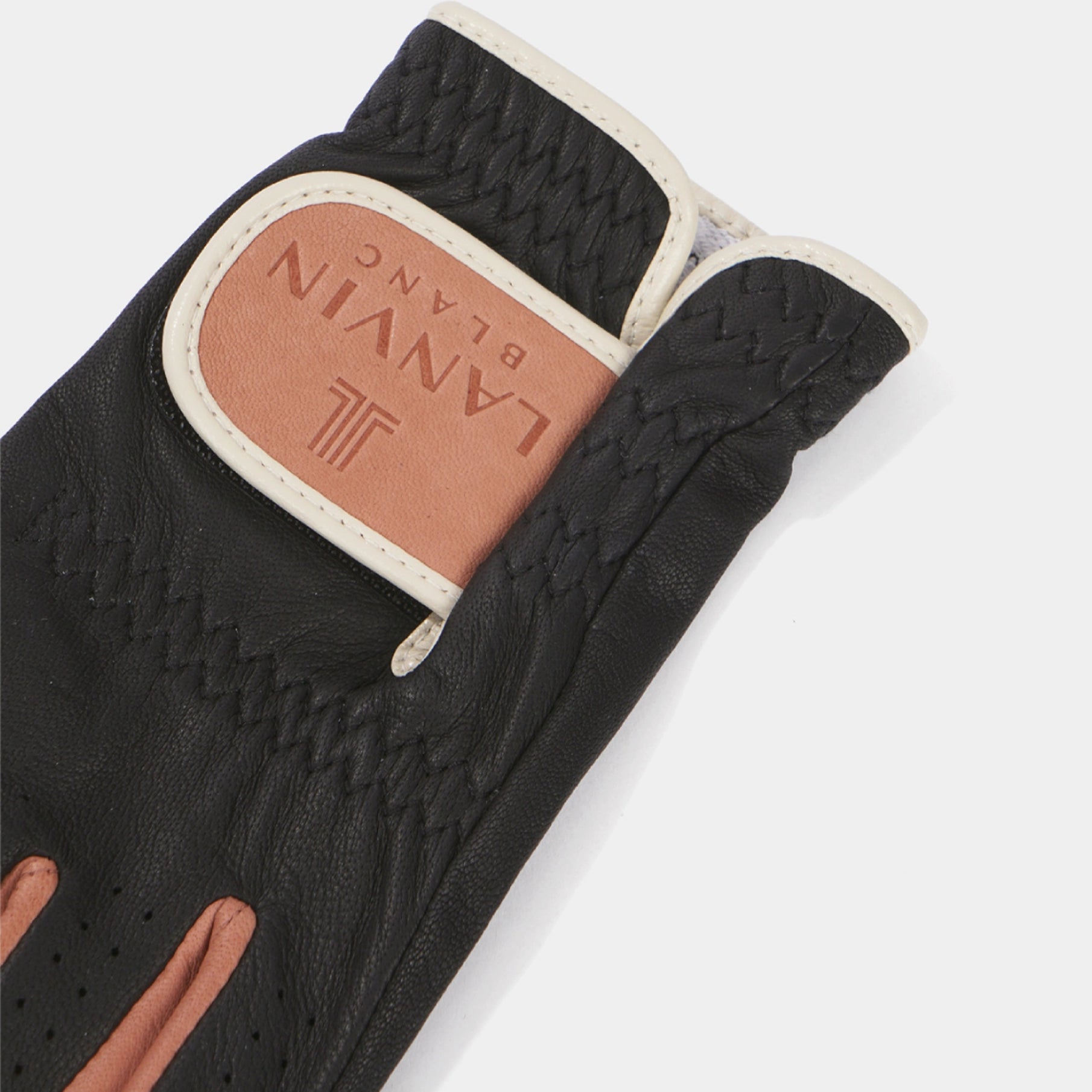 A close-up of a black leather golf glove with a tan leather brand patch reading LANVIN BLANC on the cuff, set against a light gray background.