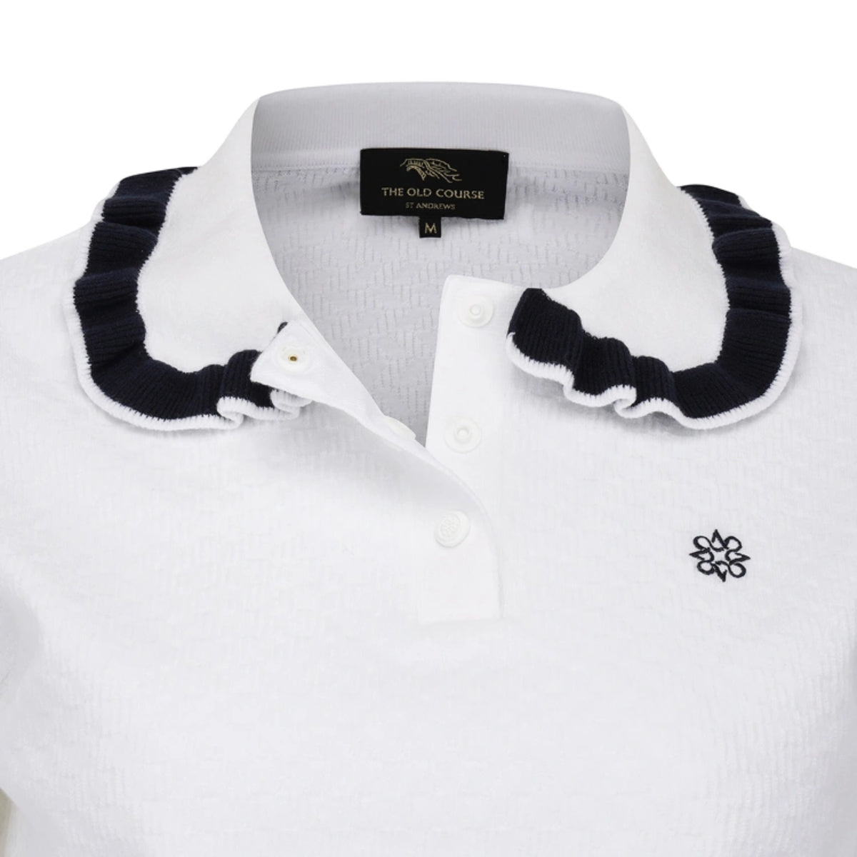 White polo shirt with a contrasting dark navy ruffled collar and a small black embroidered flower logo on the chest, shown on a white background.