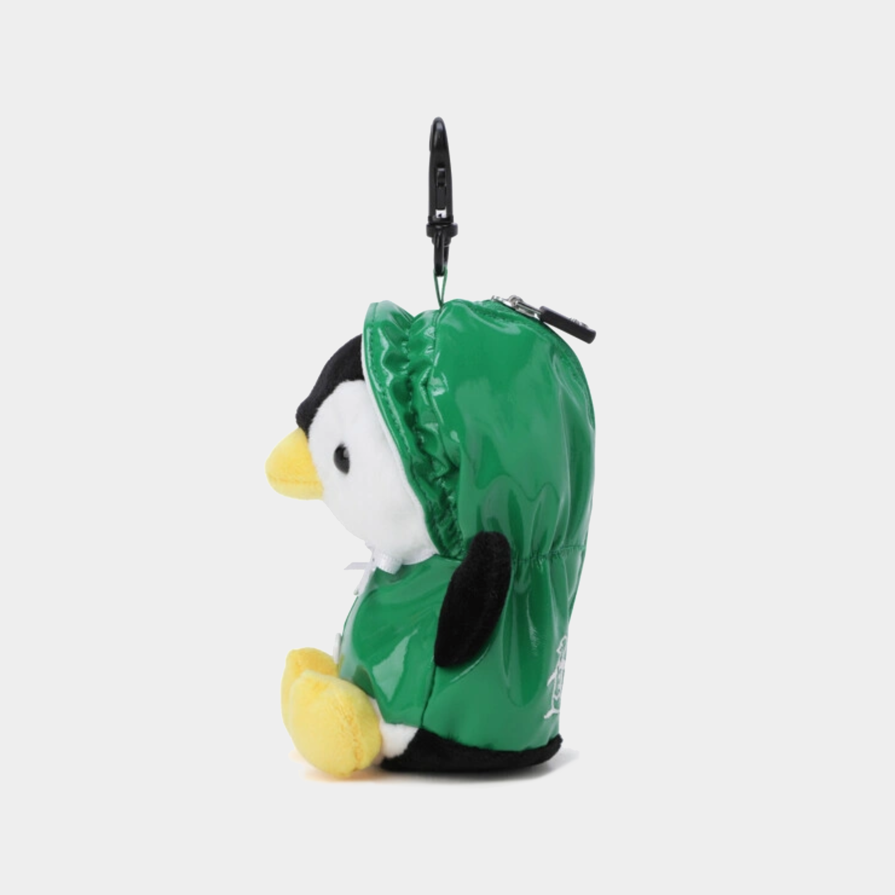 A plush penguin keychain or bag charm wearing a shiny green hood, with a black carabiner clip at the top, shown on a light gray background.