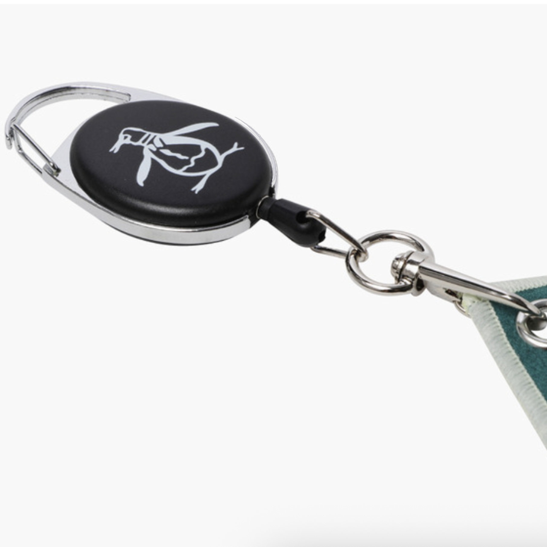 A close-up of a retractable badge reel keychain with a black oval face, silver metal frame and hardware, and a white bird logo printed on the face. A portion of a teal and white fabric strap is visible extending from the right side.