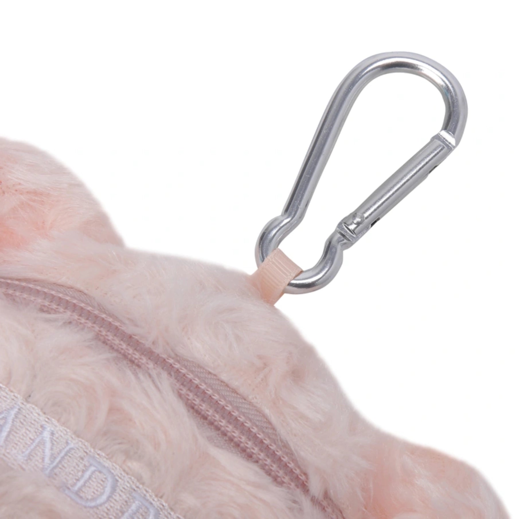 Close-up of a light pink fluffy pouch with a silver metal carabiner clip attached by a beige loop, on a white background.