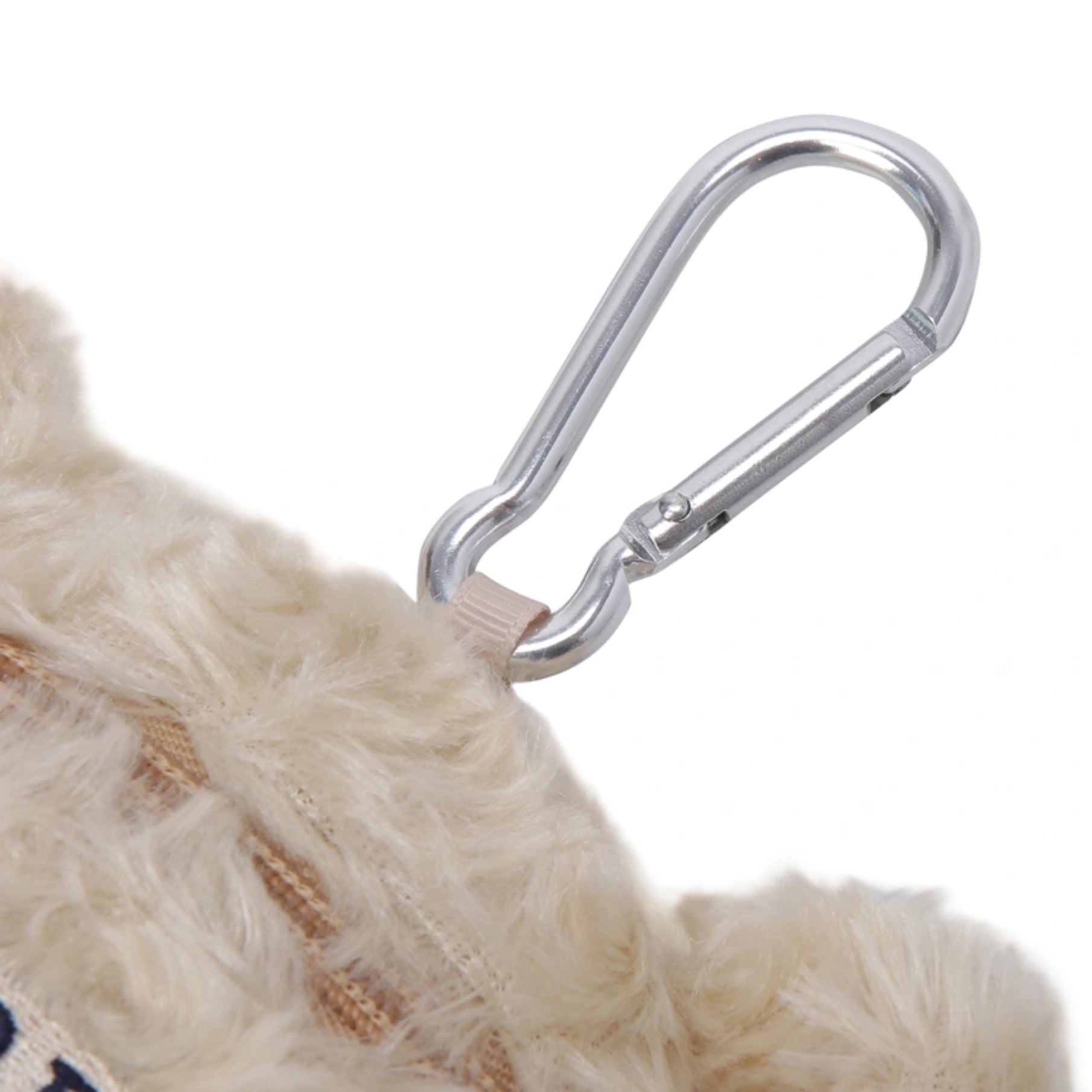 A silver metal carabiner clipped to a beige faux-fur accessory on a plain white background.