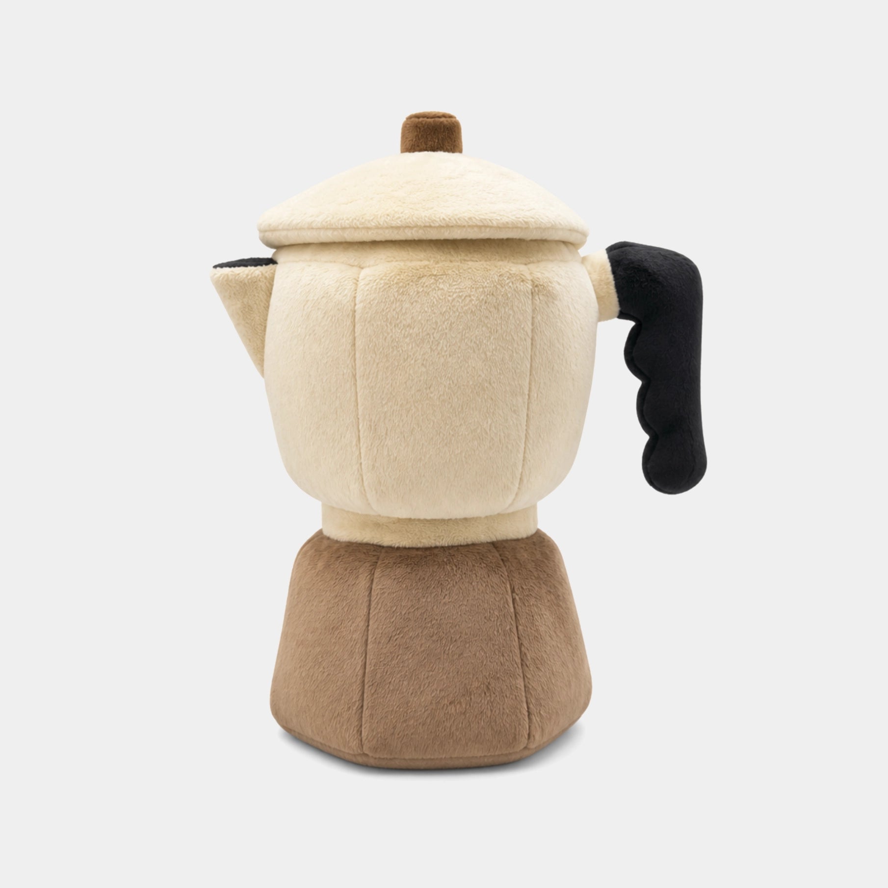 A plush moka pot wood cover with a cream-colored body and lid, a brown base, and a black handle, photographed on a light gray background.