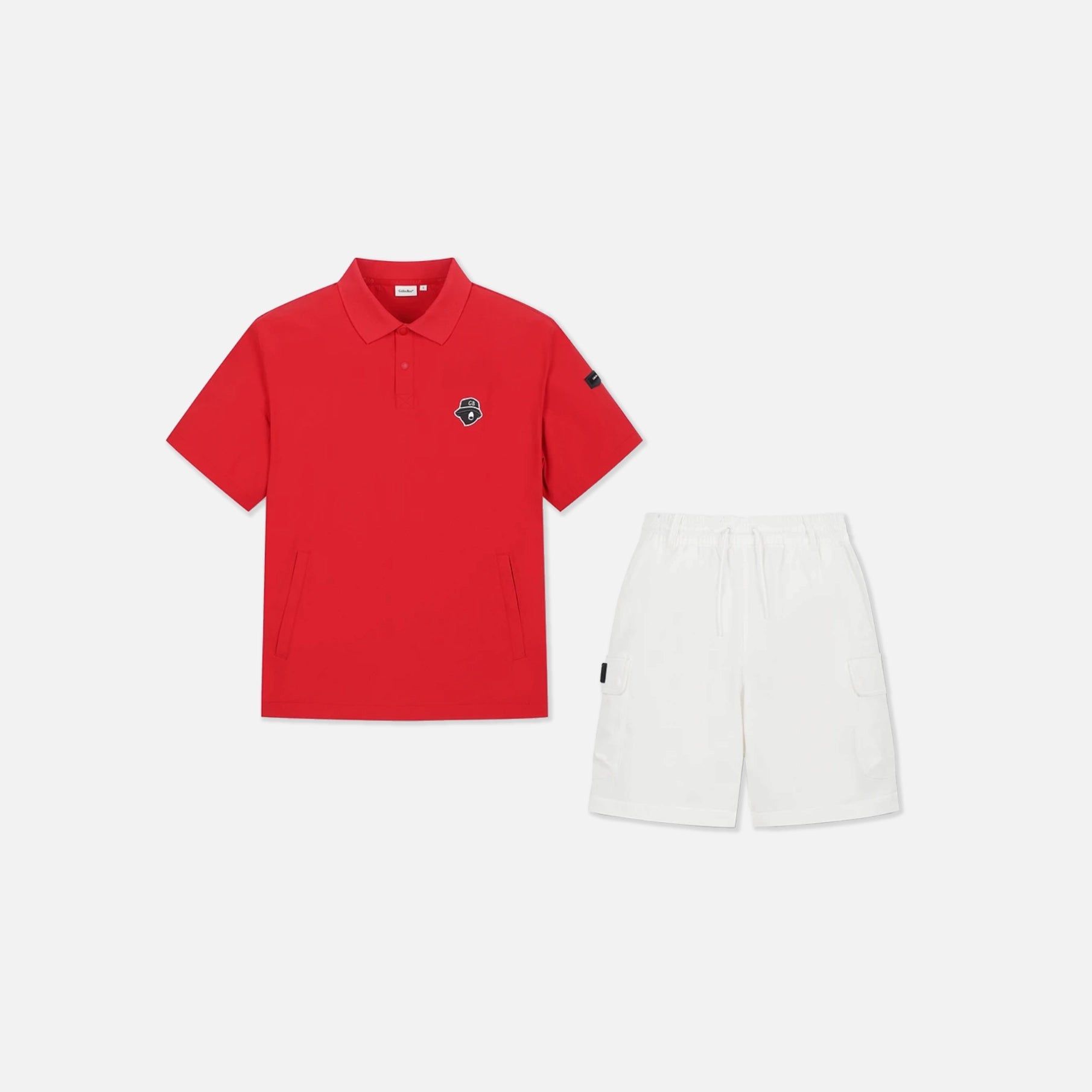 A two-piece adult' outfit set featuring a bright red short-sleeve polo shirt with a small embroidered logo on the left chest, paired with white shorts, displayed on a clean light gray background.