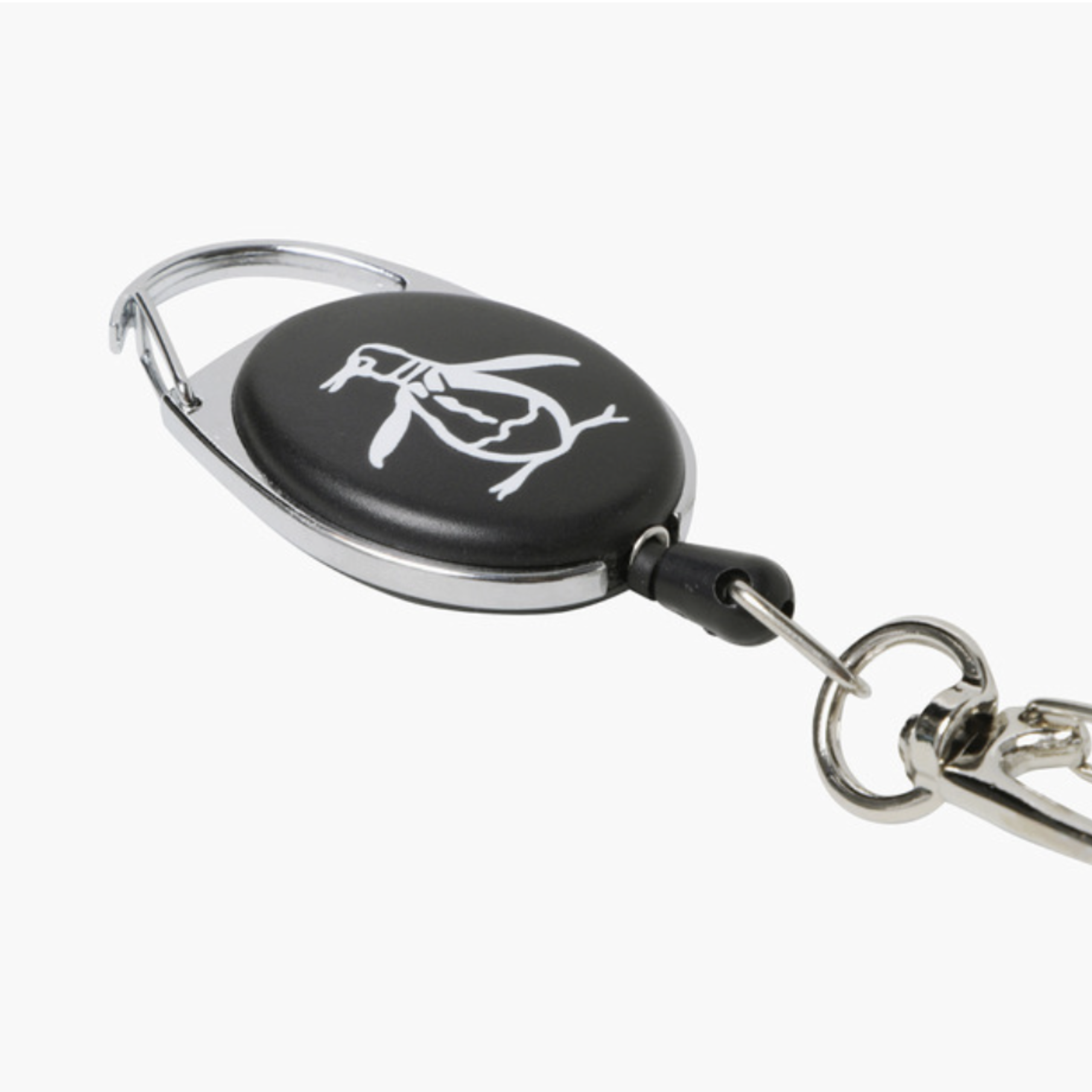 A retractable badge reel keychain with a black oval face featuring a white penguin logo, finished with silver metal hardware including a carabiner clip, extension cord, and key ring on a light gray background.