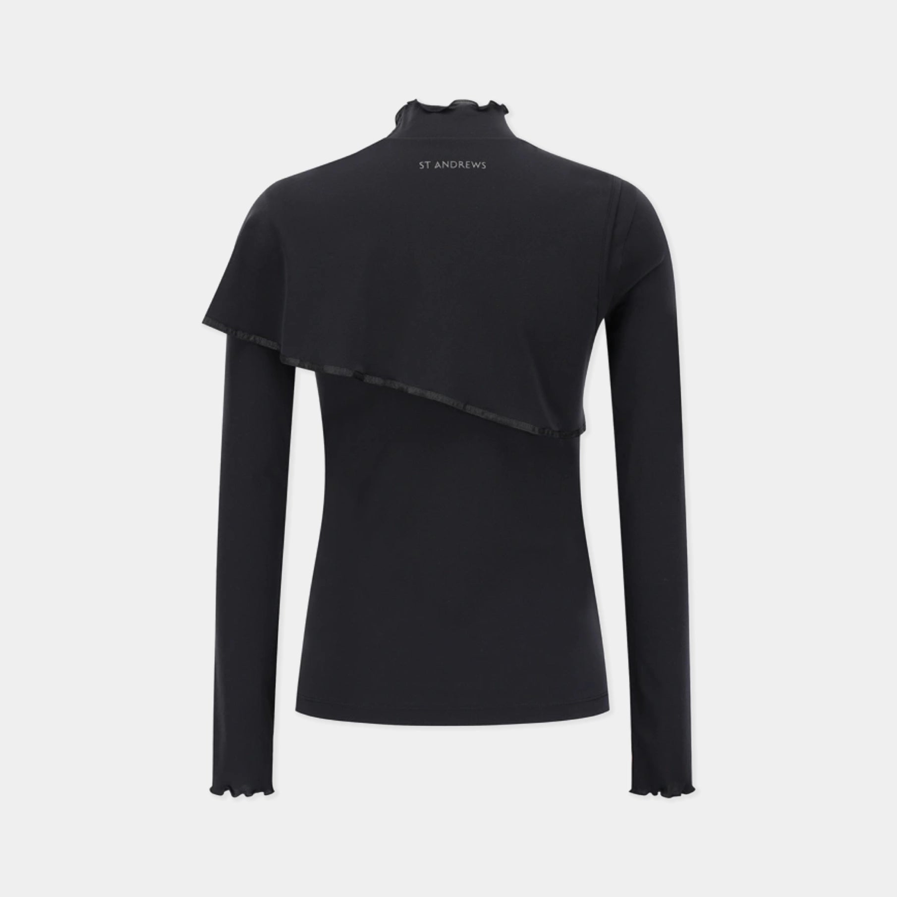 A black long-sleeve mock neck top with an asymmetrical draped overlay and ruffled edges, featuring the brand name 'ST ANDREWS' printed in white on the back of the neck, shown against a light gray background.