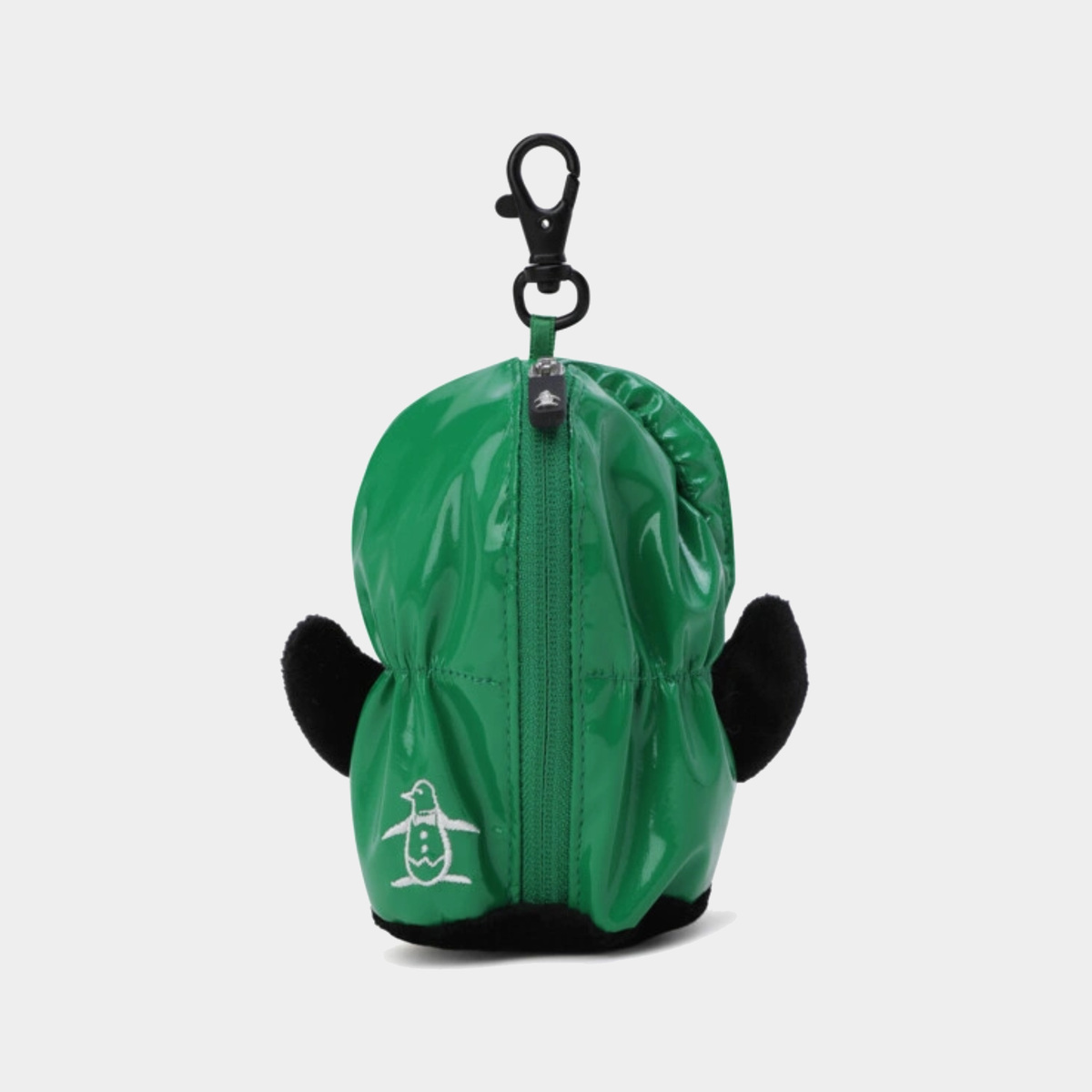 A green waterproof penguin-shaped golf ball case with black plush ears, a black lobster clasp, and a white penguin logo on the front, shown against a light gray background.