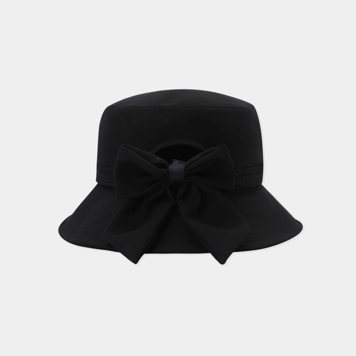 A black bucket hat with a large matching fabric bow on the front, photographed against a solid light gray background.