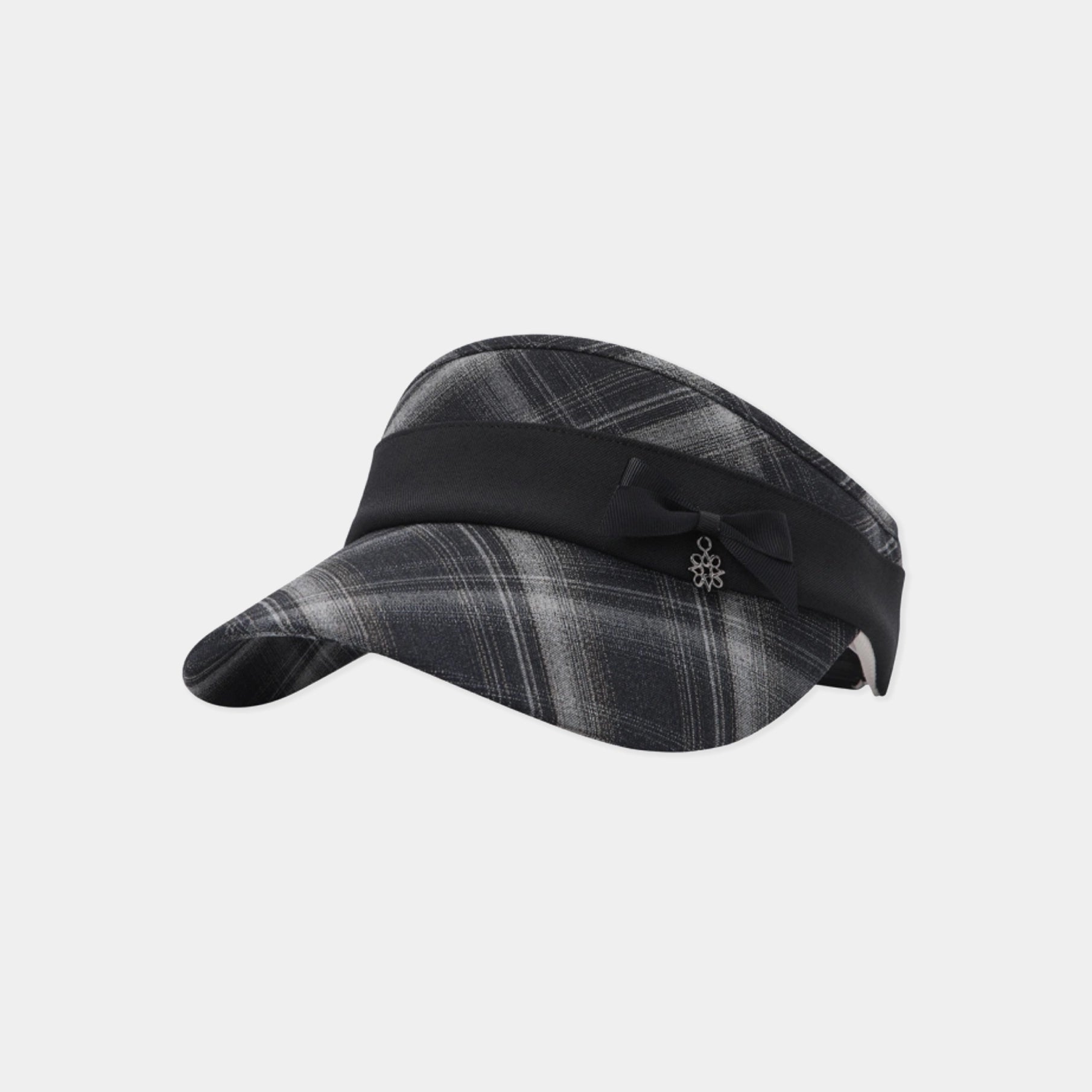 A women's visor hat featuring a dark gray and black plaid pattern on the crown and brim, accented by a wide black band with a small black bow and silver floral emblem on the side.
