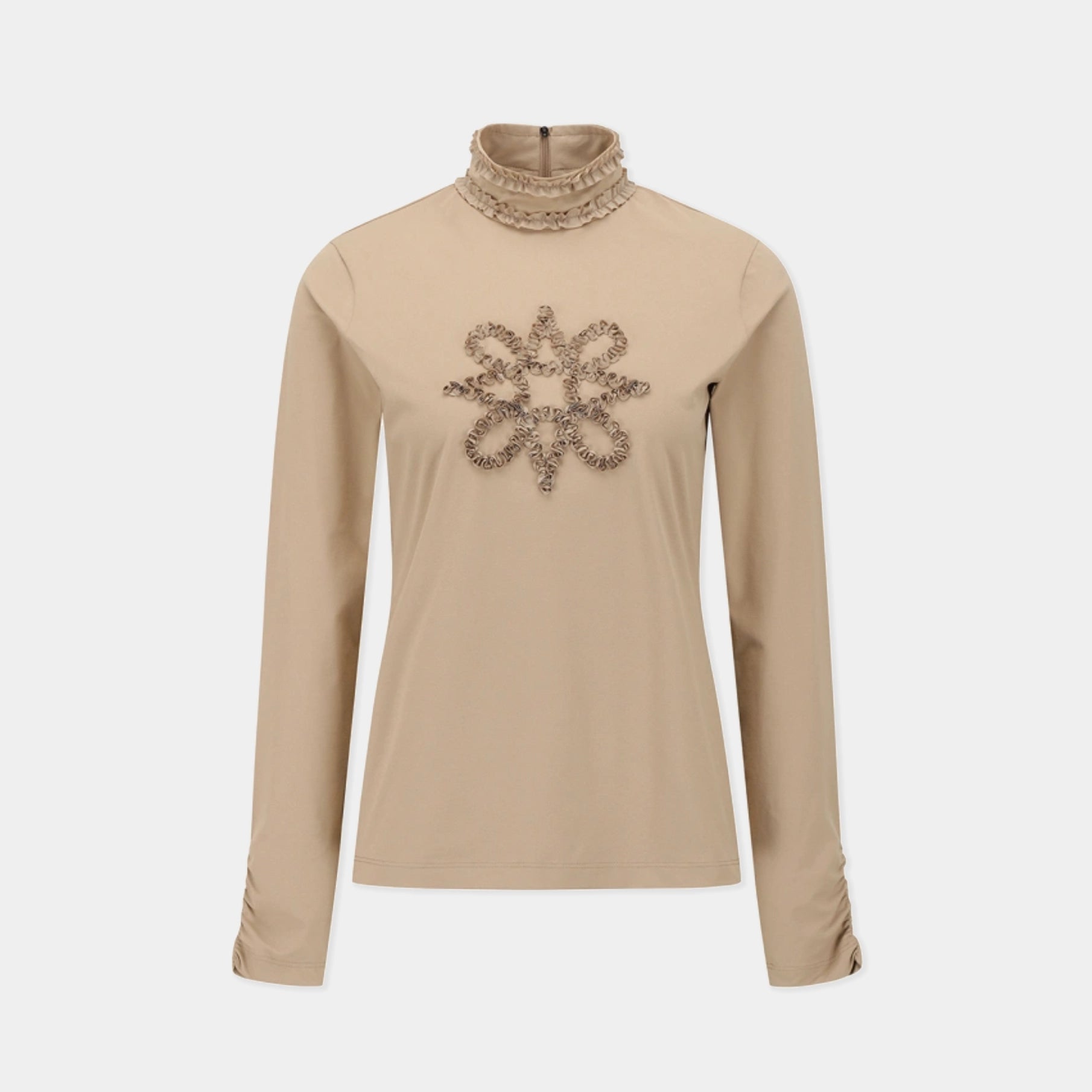 A beige long-sleeve mock neck top with a decorative beaded snowflake design on the chest, displayed on a neutral light gray background.