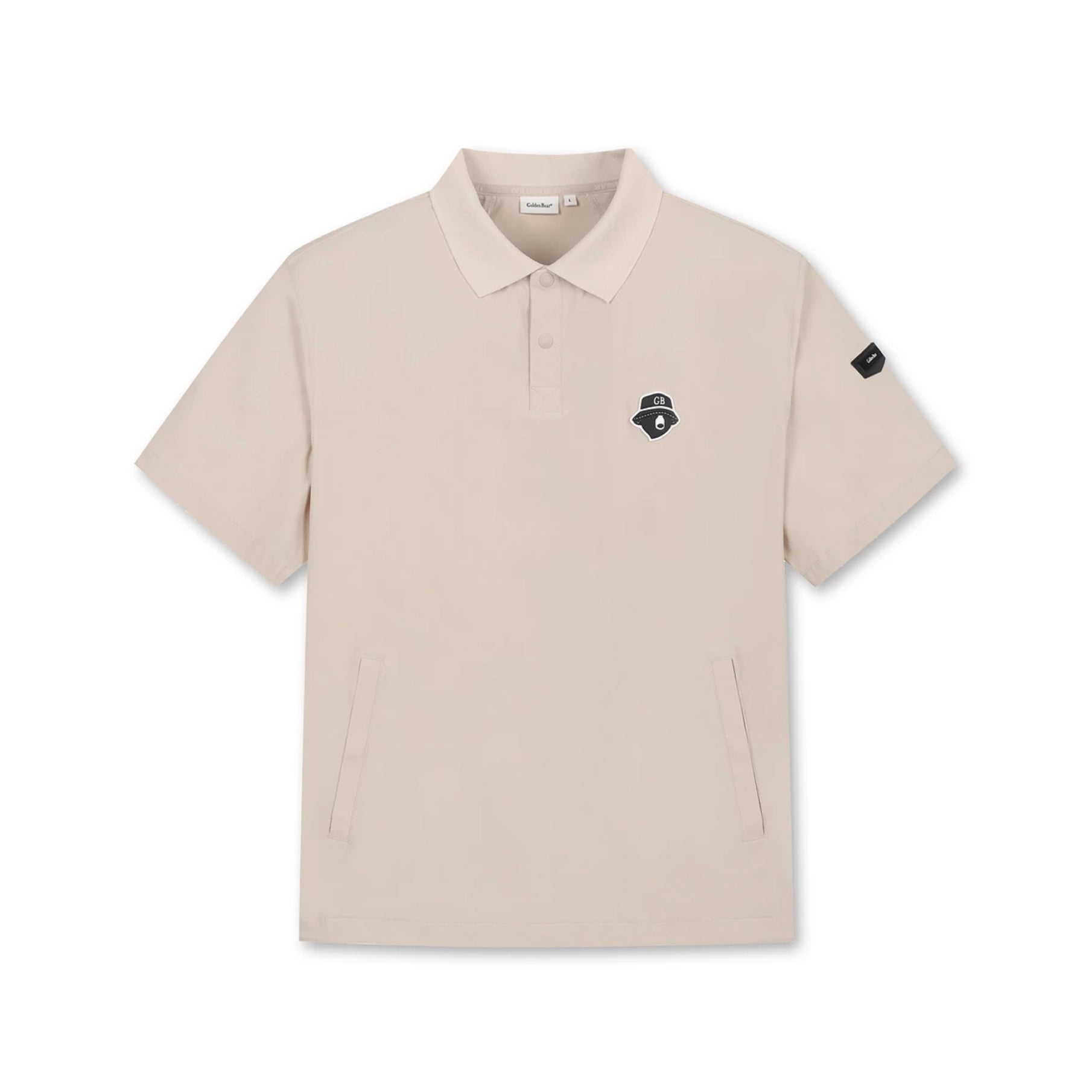 A beige short-sleeve polo shirt with a small black embroidered logo on the left chest and a black sleeve patch, displayed on a clean white background.