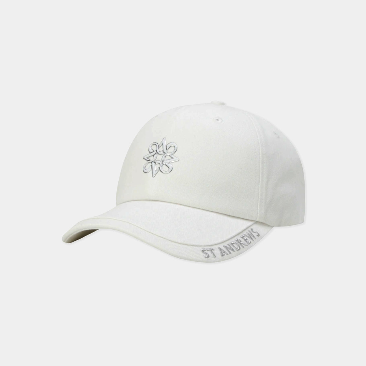 An off-white baseball cap featuring a small gray embroidered flower on the front and 'ST. ANDREWS' embroidered in gray on the side of the brim, set against a light gray background.