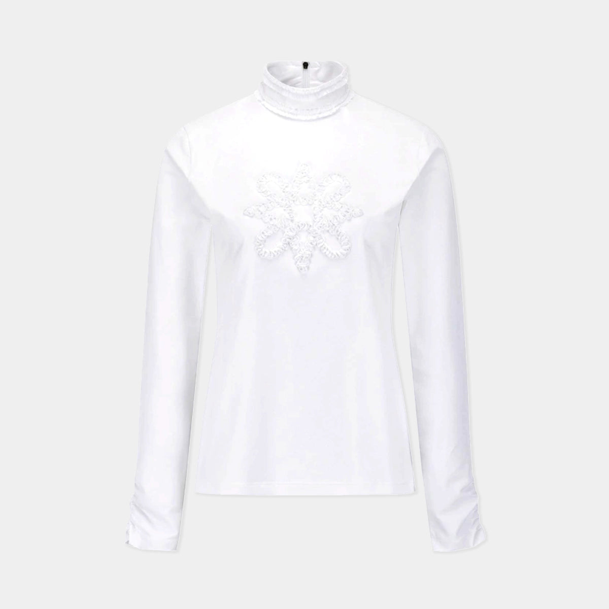 A white long-sleeve mock neck top with a textured, raised snowflake or floral applique detail on the center chest, displayed on a light gray background.
