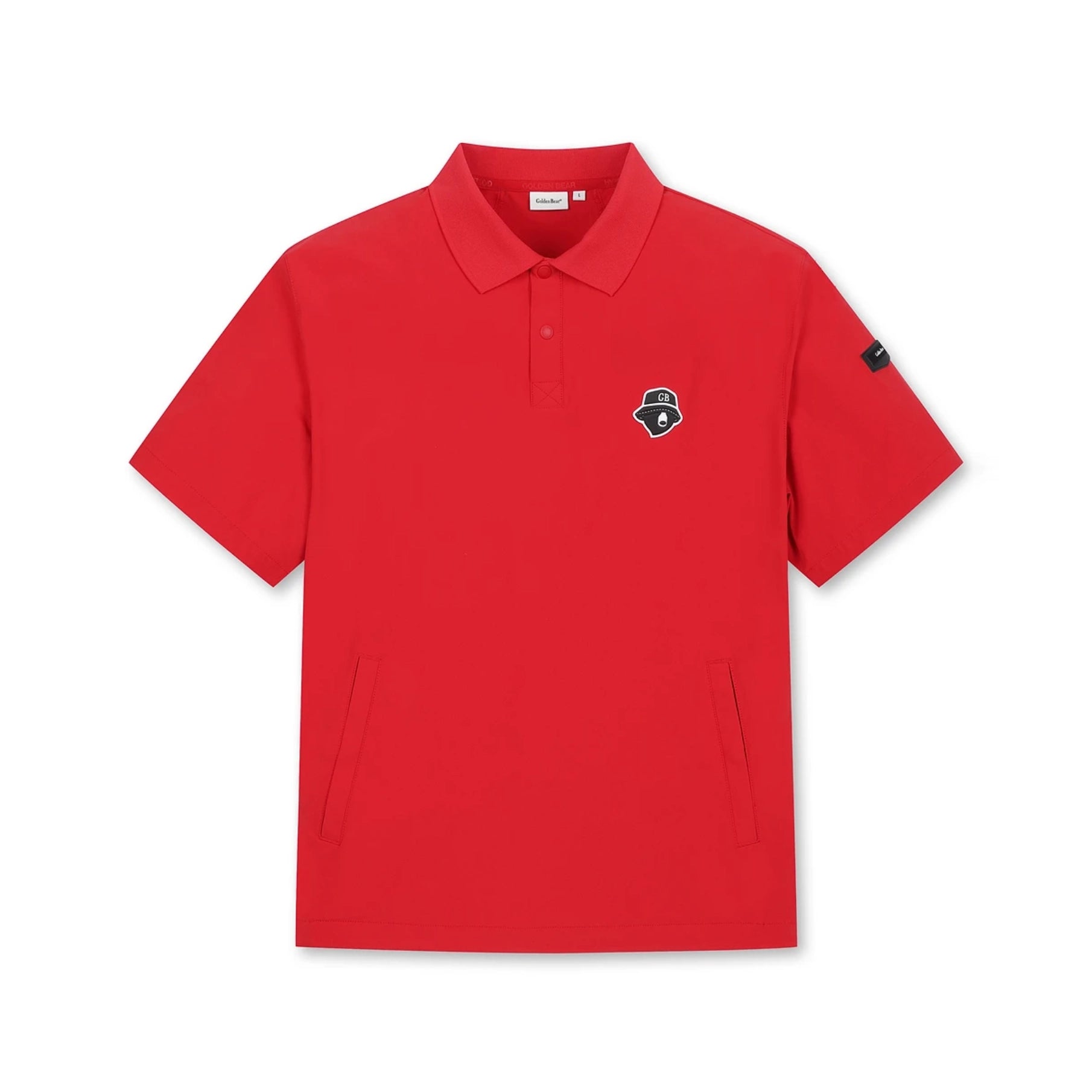 A bright red short-sleeve polo shirt with a small embroidered shield logo on the left chest and a black sleeve patch, displayed flat against a solid white background.