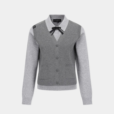 A gray and light gray color-blocked cardigan sweater with a black bow at the collar, shown on a light gray background.