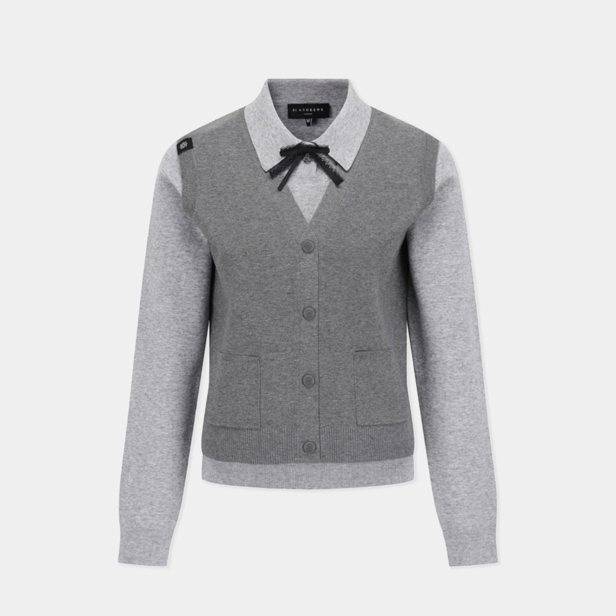 A gray and light gray color-blocked cardigan sweater with a black bow at the collar, shown on a light gray background.