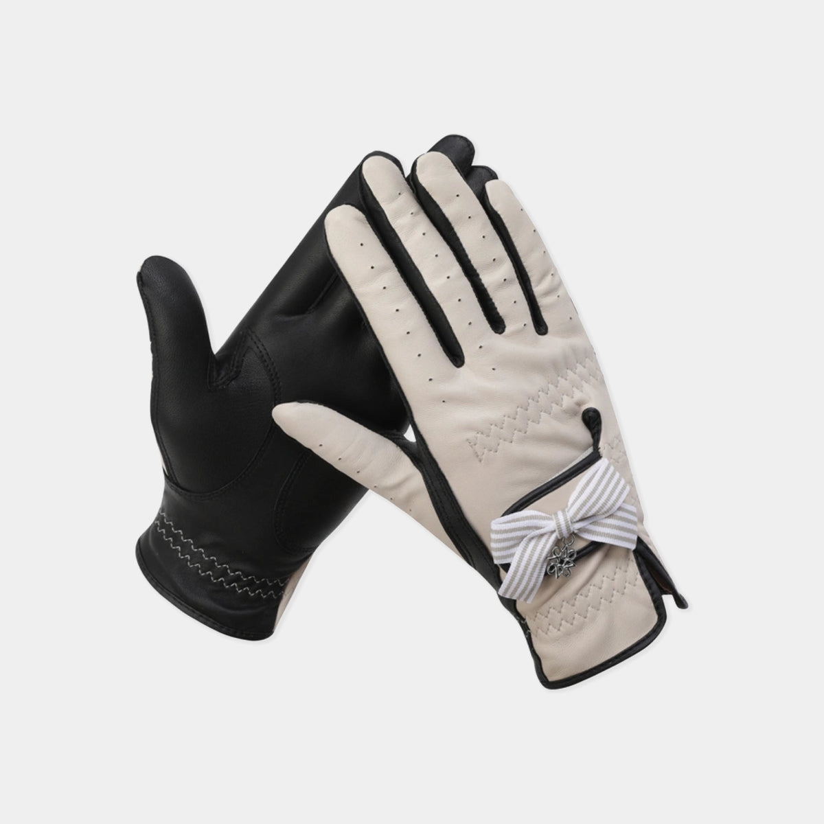 Women's beige and black leather golf glove with ribbon detail, shown as a pair.